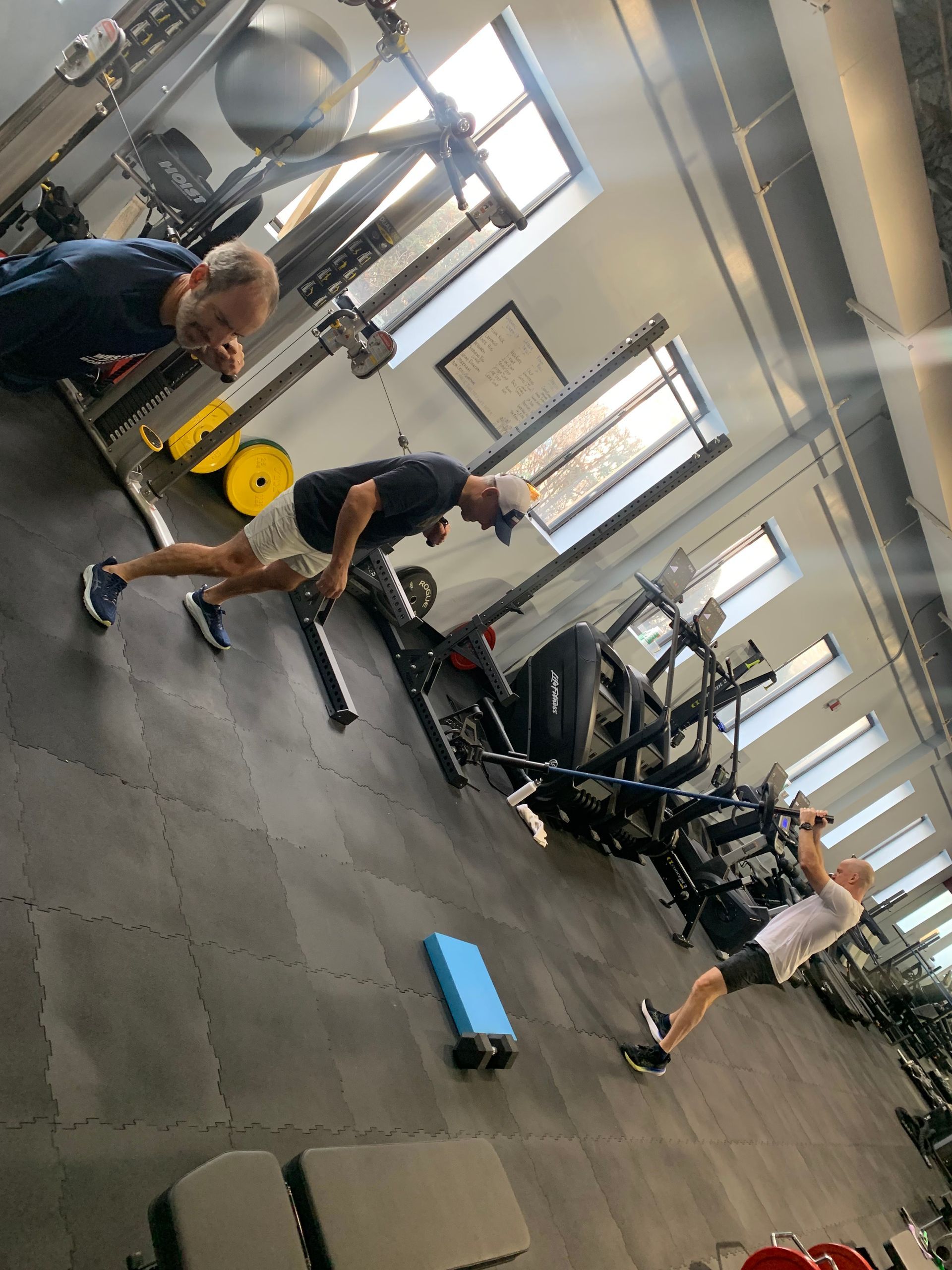 A group of people are doing exercises in a gym.