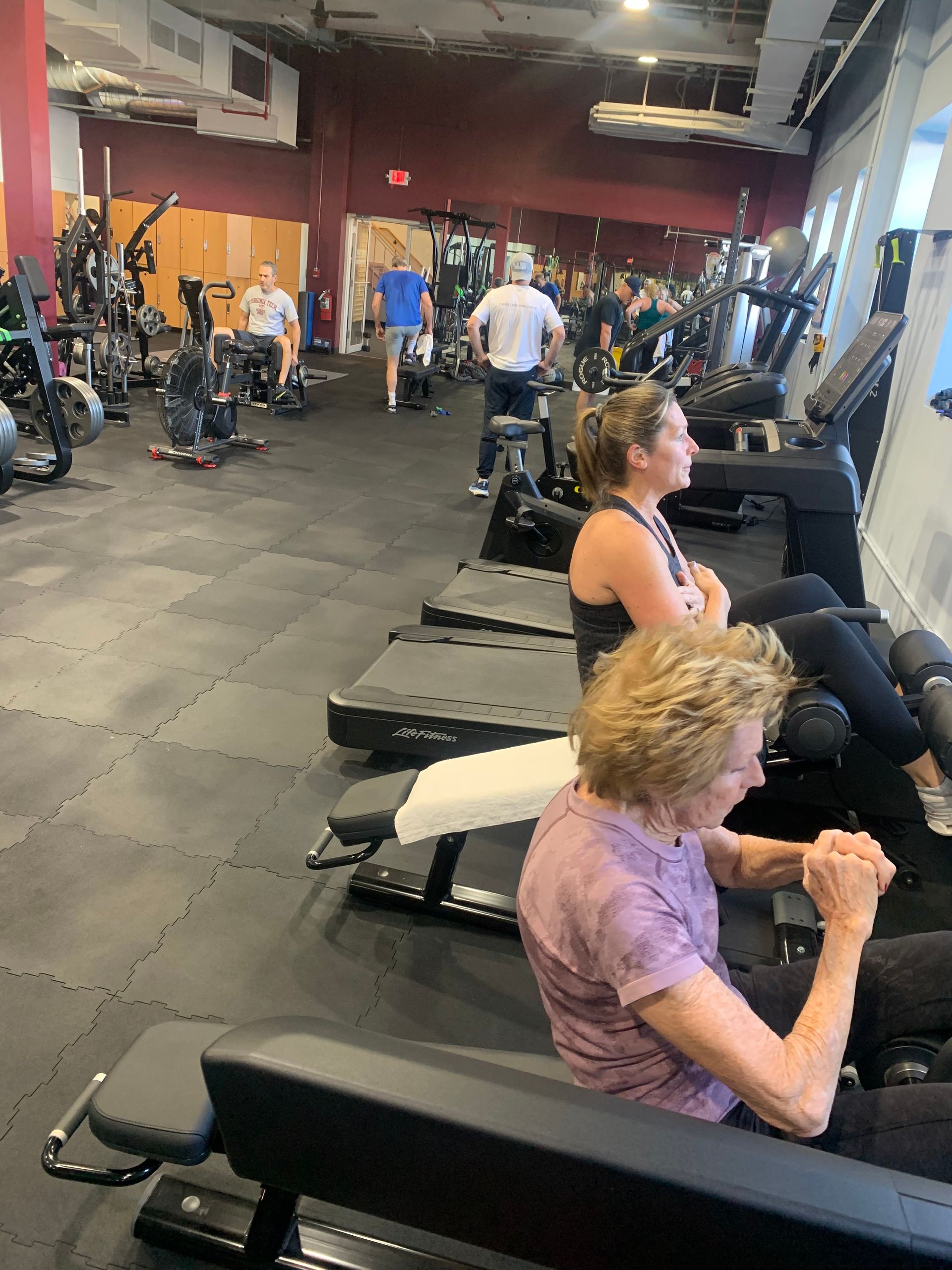 A group of people are working out in a gym.