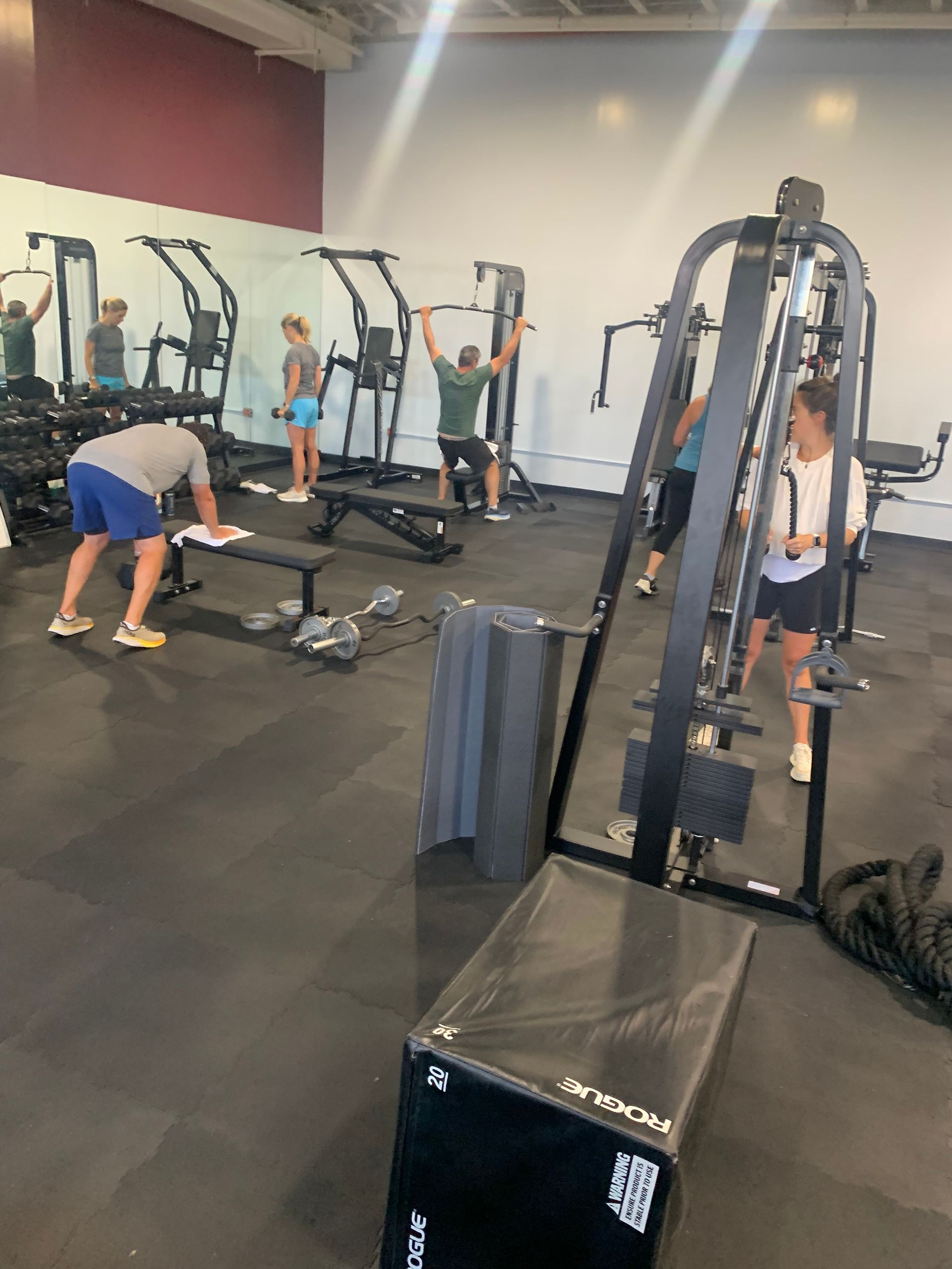 A group of people are working out in a gym.
