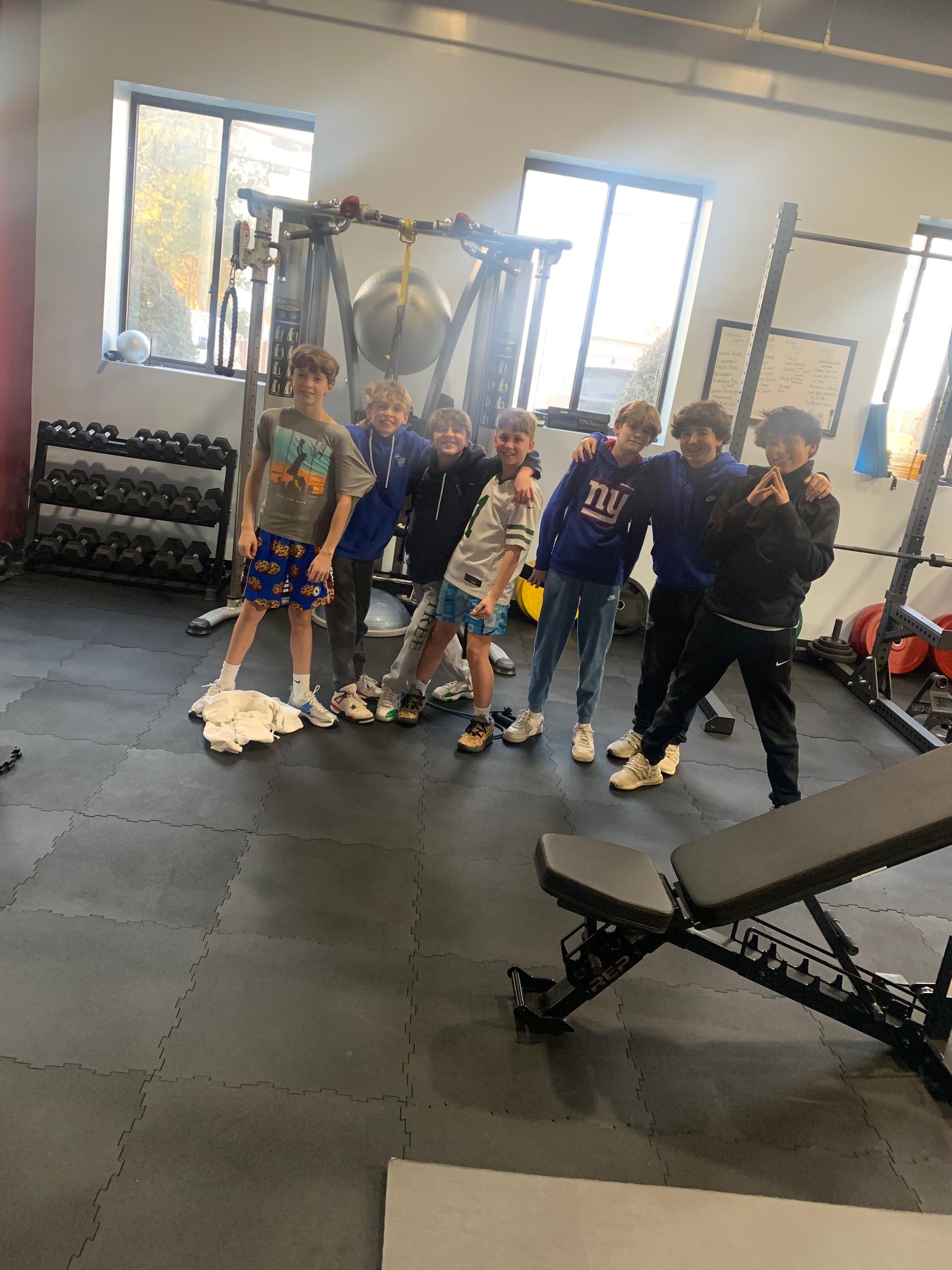 A group of children are posing for a picture in a gym.