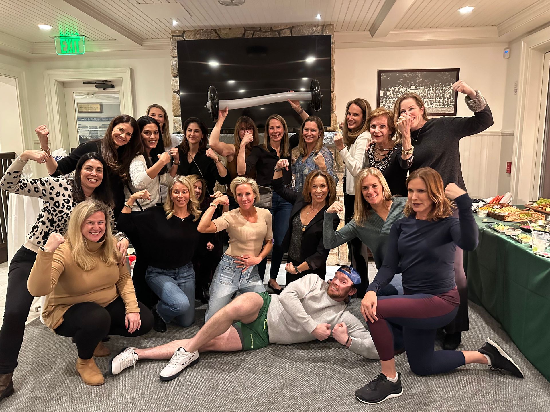 A group of people are posing for a picture in a room.