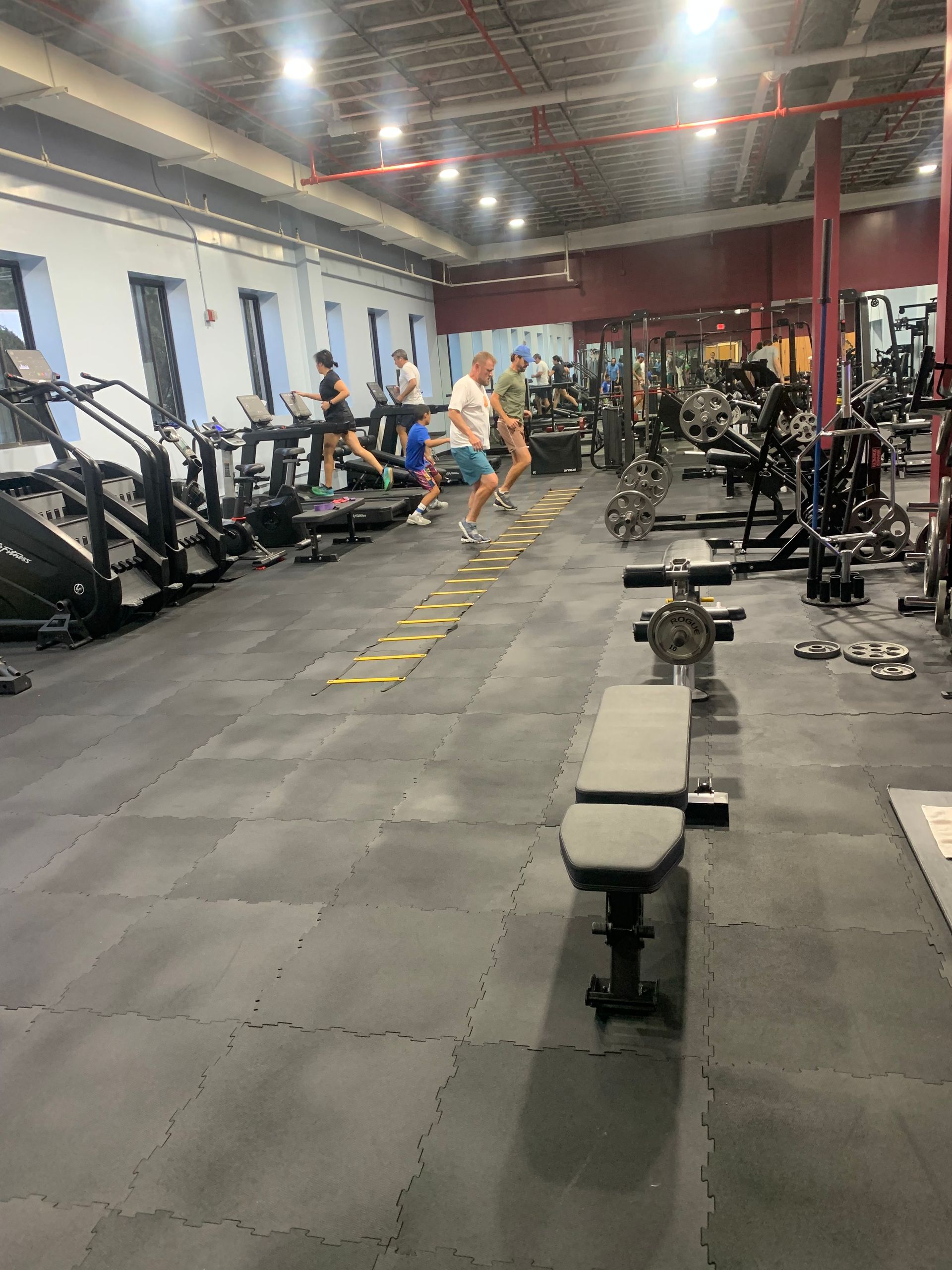 A man is running on a treadmill in a gym.