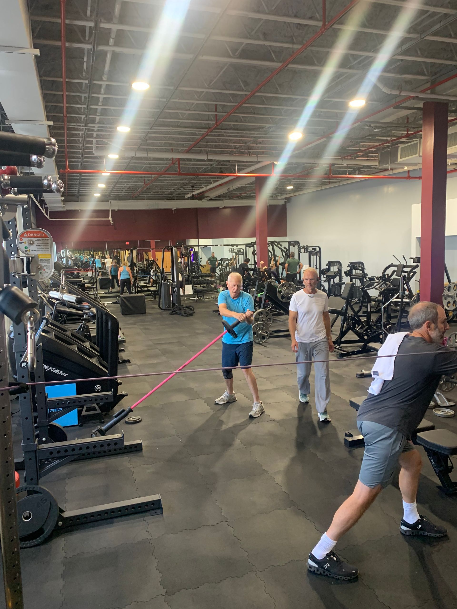 A group of men are working out in a gym.