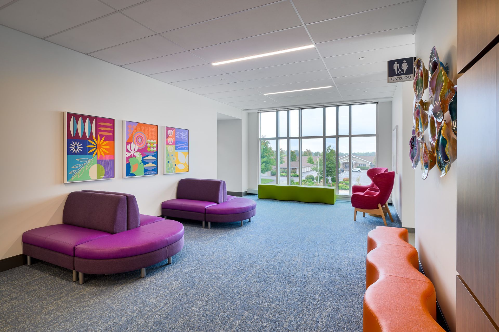 A big waiting area with colorful couches 