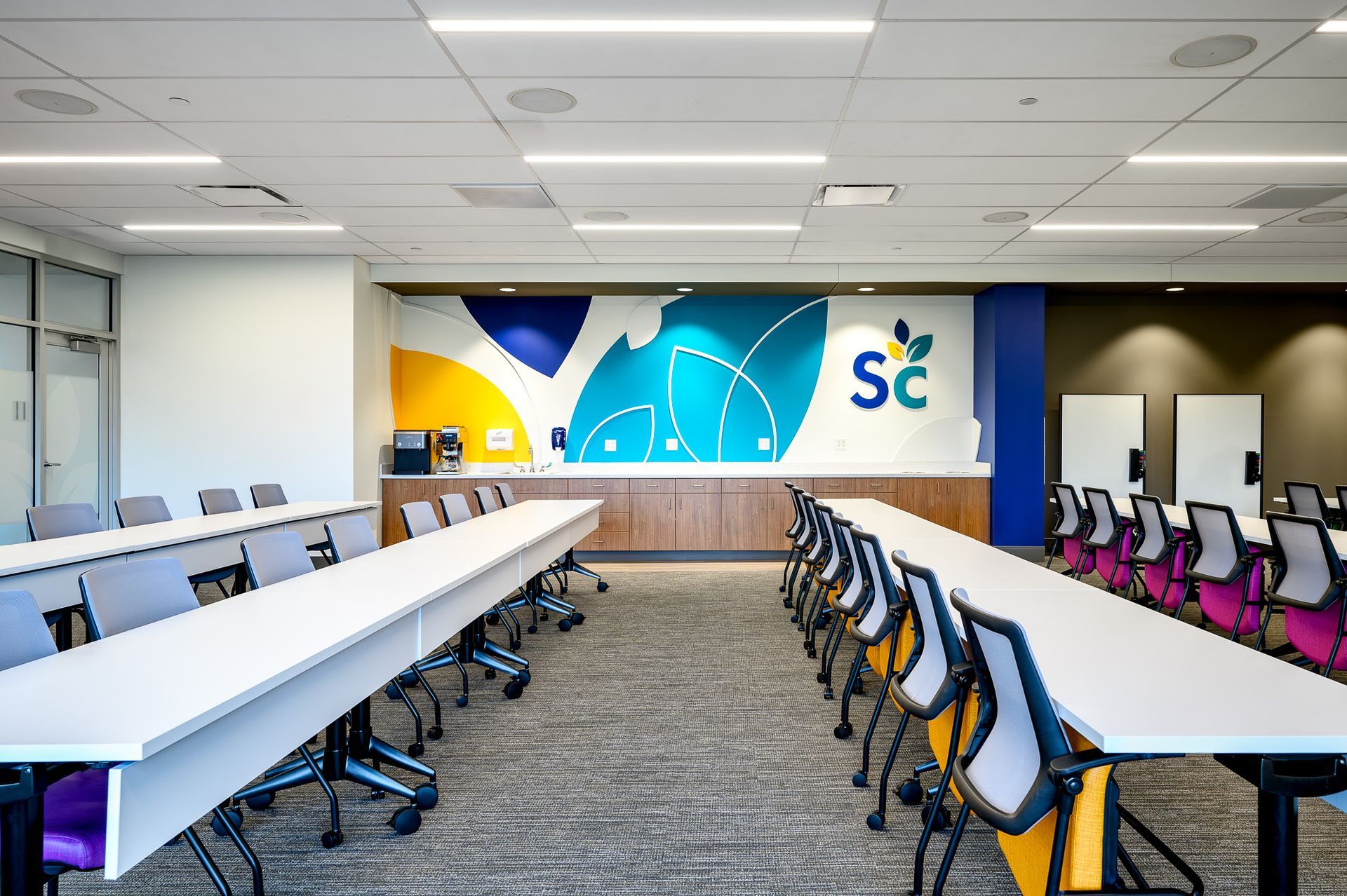 An office with white tables and chairs