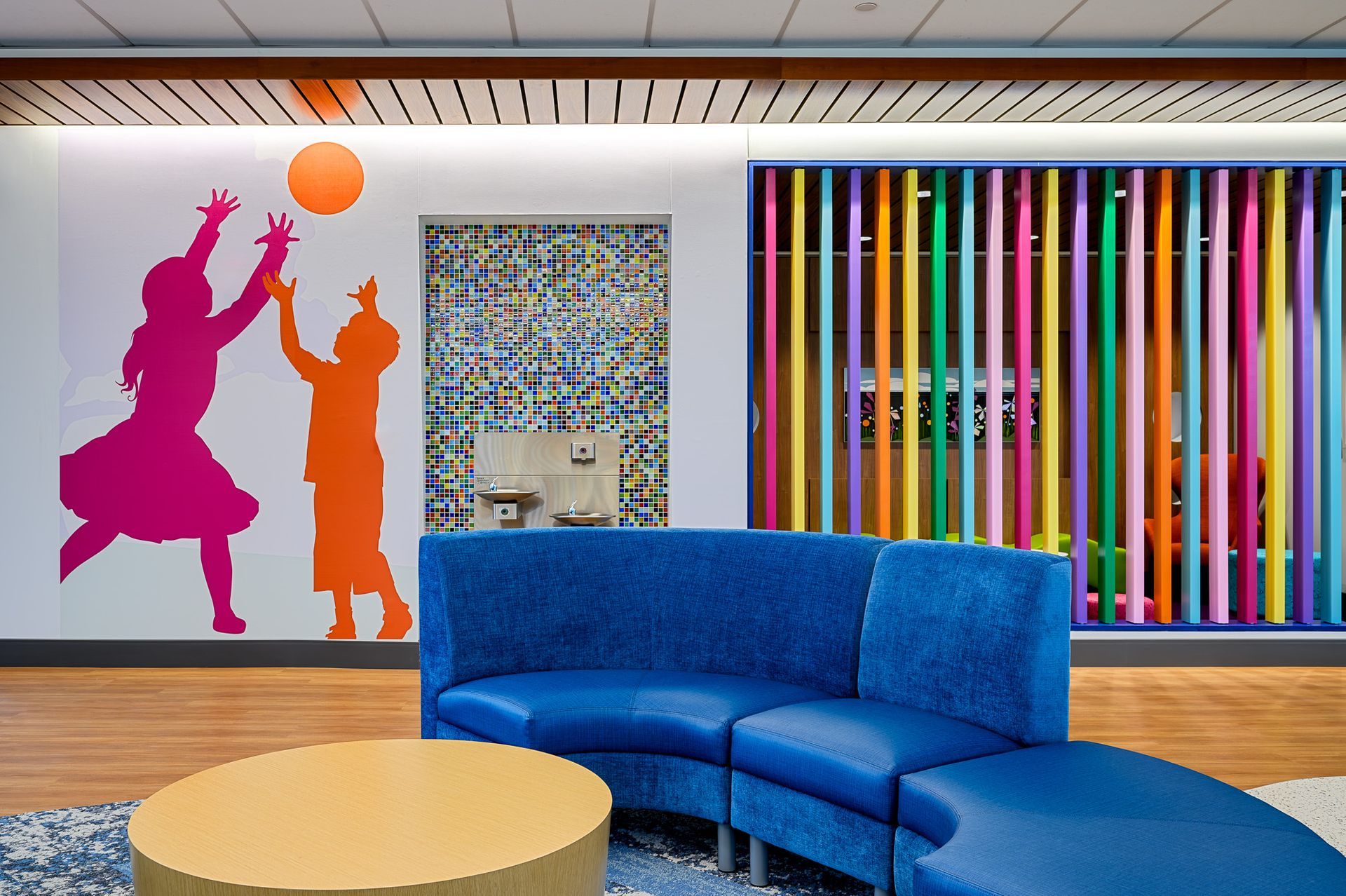 A waiting room with comfortable couch and beautiful wall designs