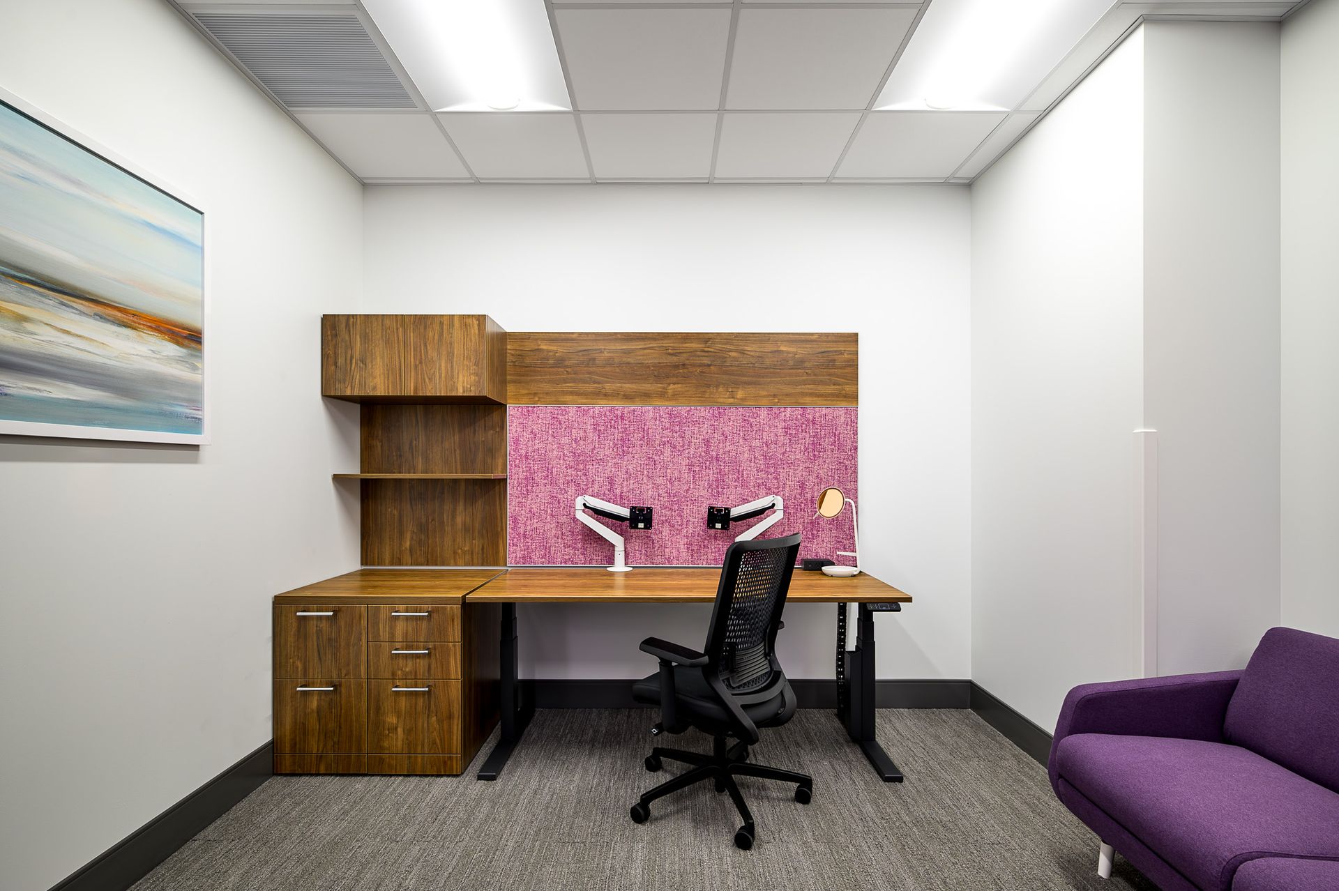 A small office with wooden table 
