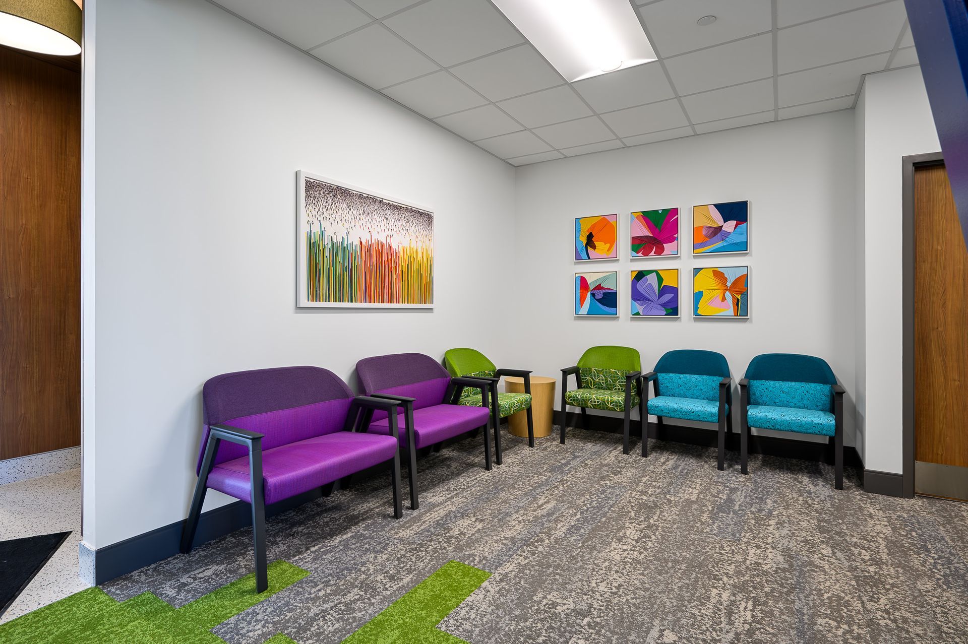 A white room with colorful chairs