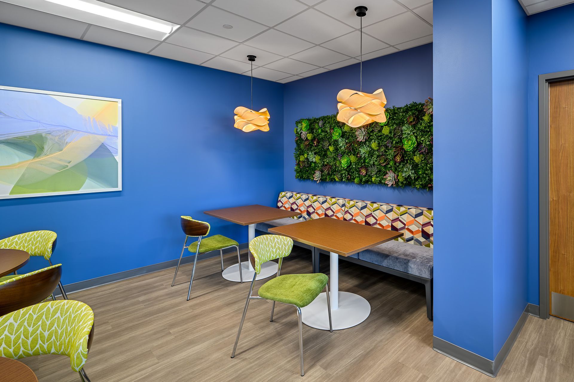 A blue-painted room with tables and chairs