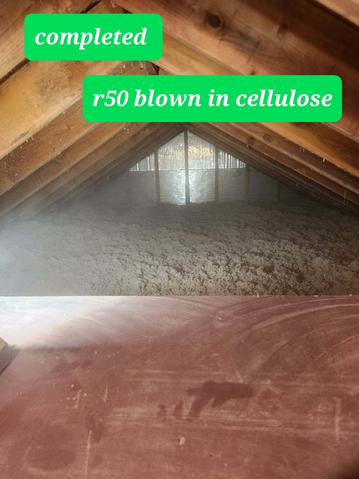 A picture of an attic that has been blown in cellulose.