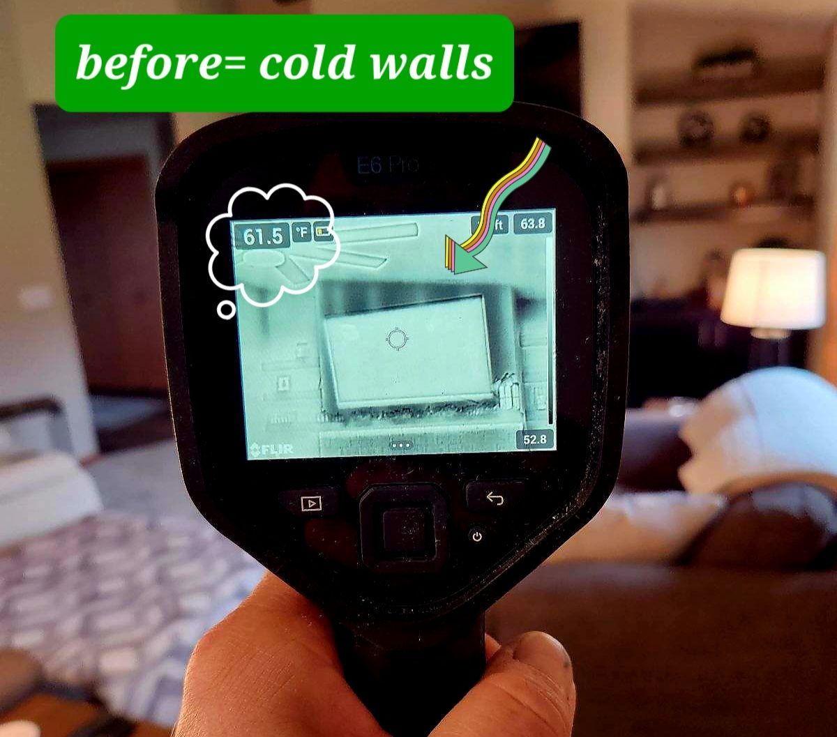 A person is holding a thermal camera with a sign that says before cold walls