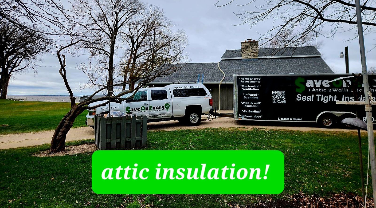 A truck and a trailer are parked in front of a house.