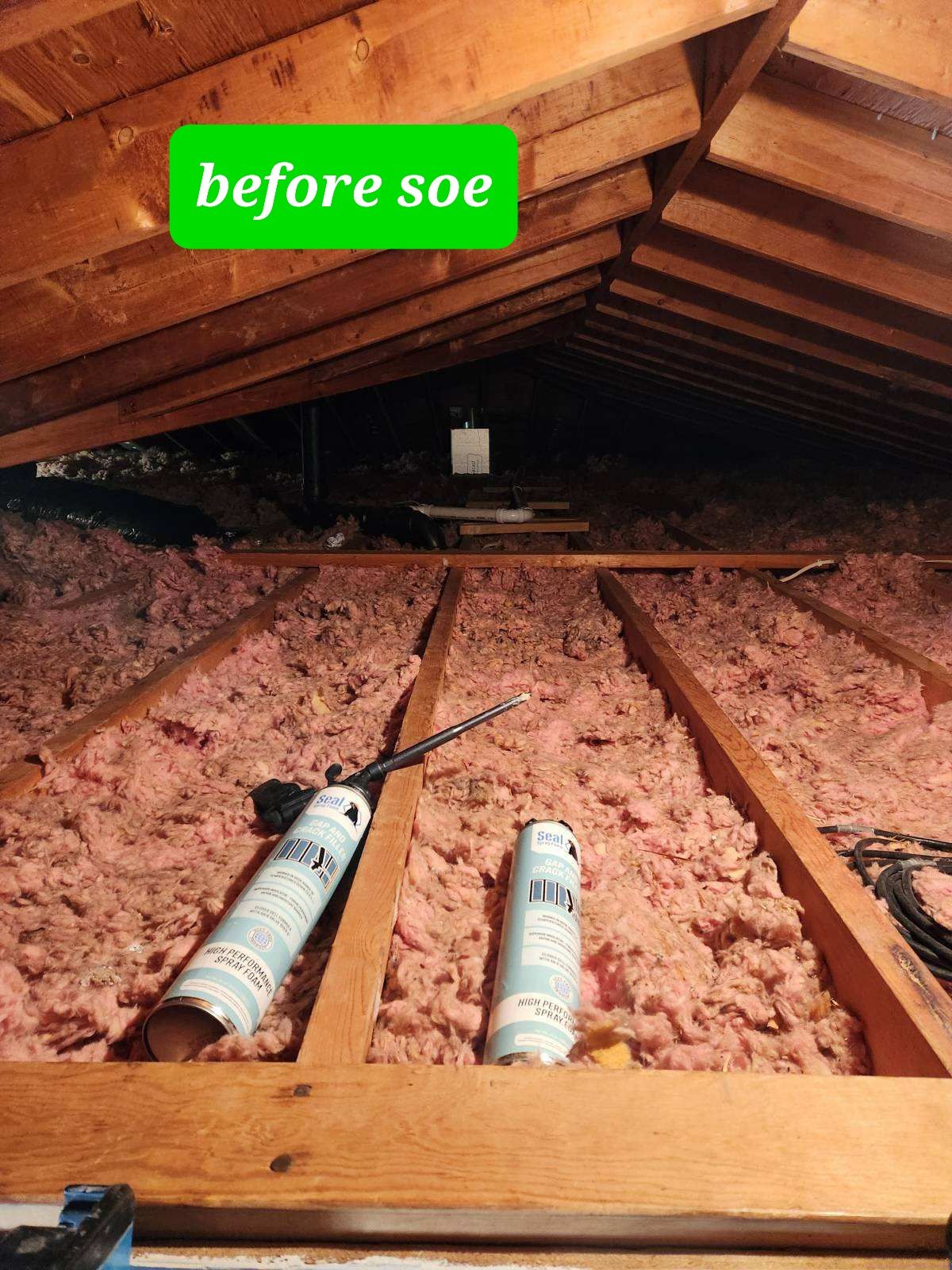 A picture of an attic before being insulated.