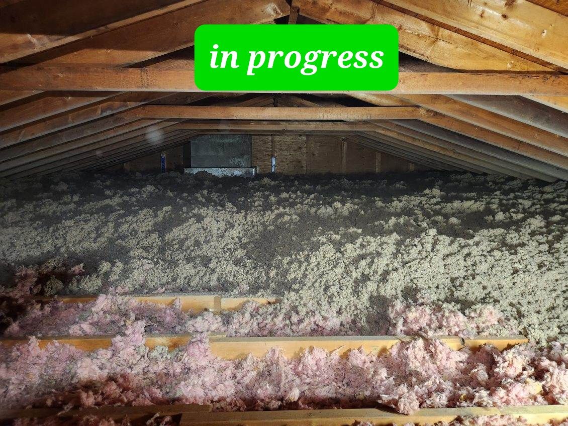 An attic with a green sign that says in progress