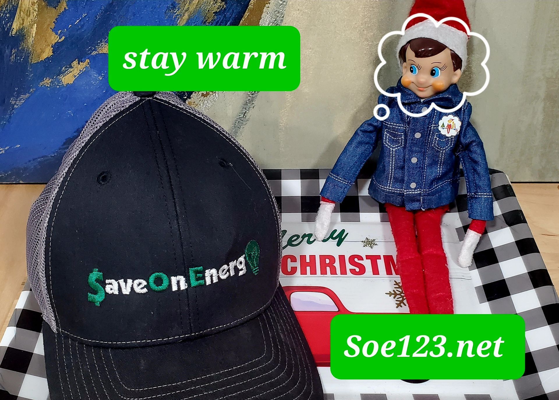 An elf on the shelf is wearing a hat that says “Save on Energy.”
