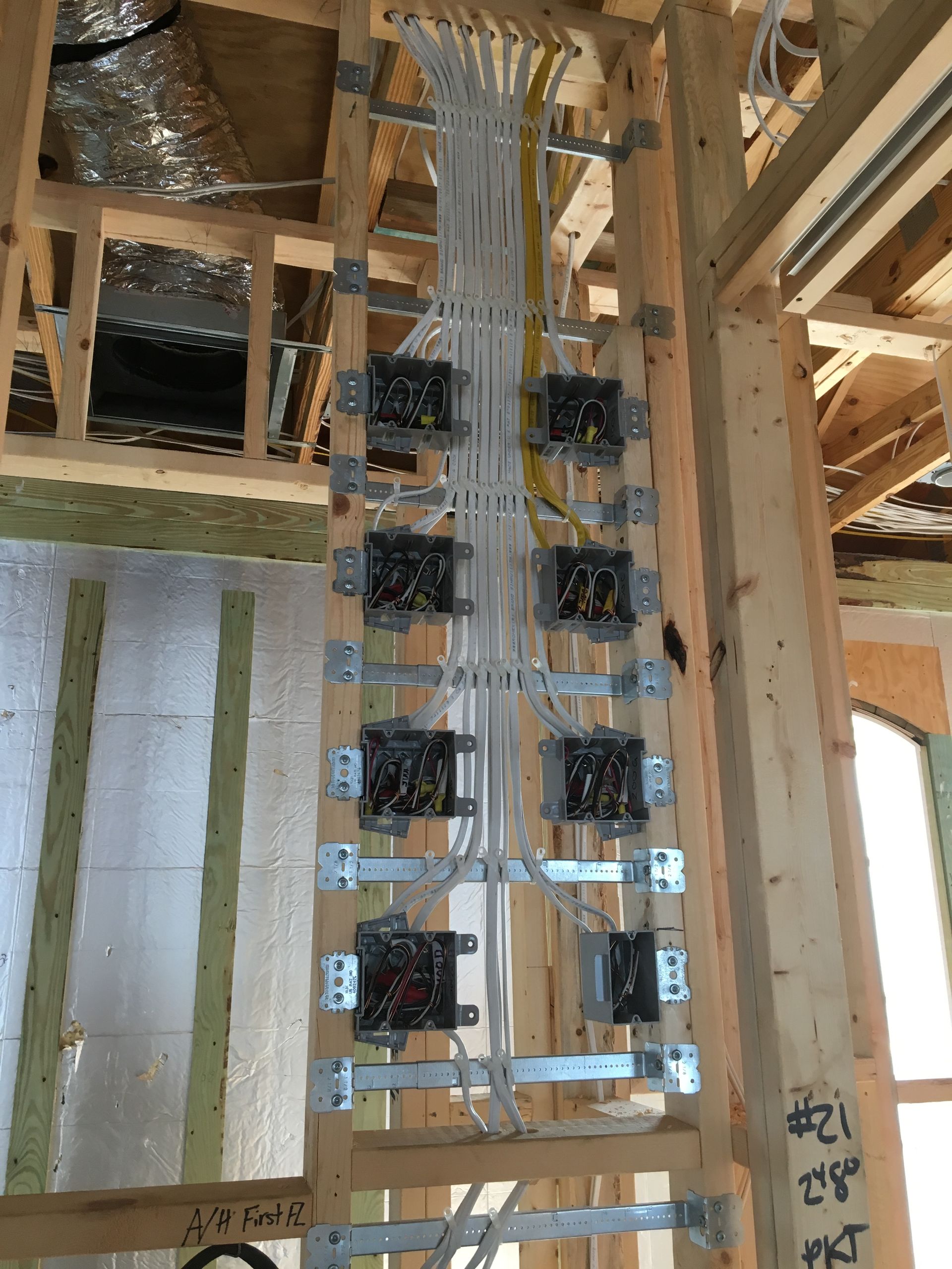 A wooden structure with electrical wires coming out of it.