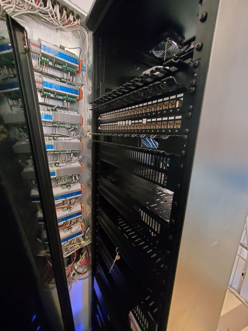 A server rack with a lot of wires coming out of it.
