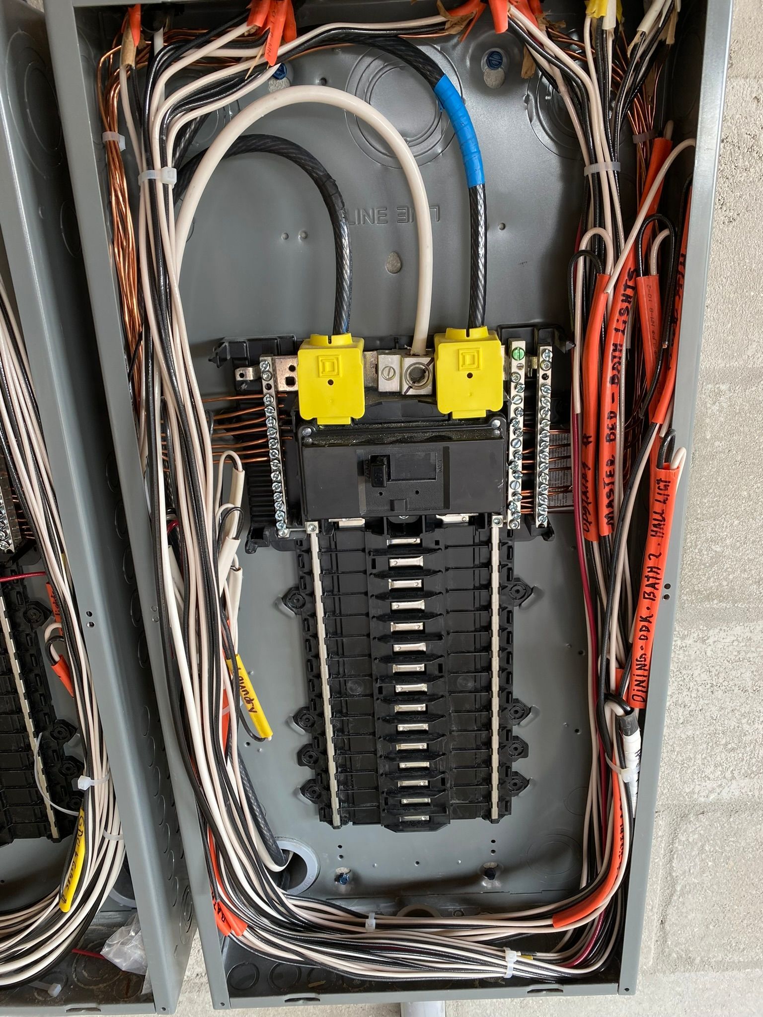 A close up of a electrical box with a lot of wires coming out of it.