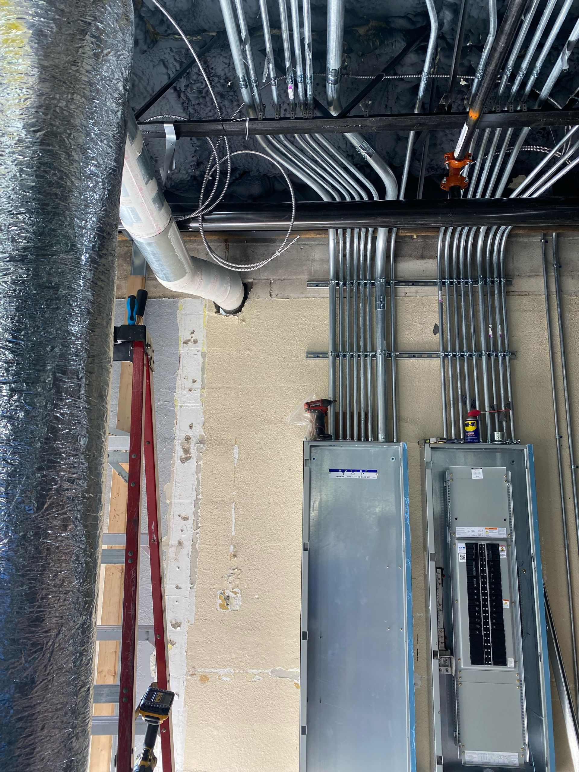 A room with a lot of electrical wires hanging from the ceiling.