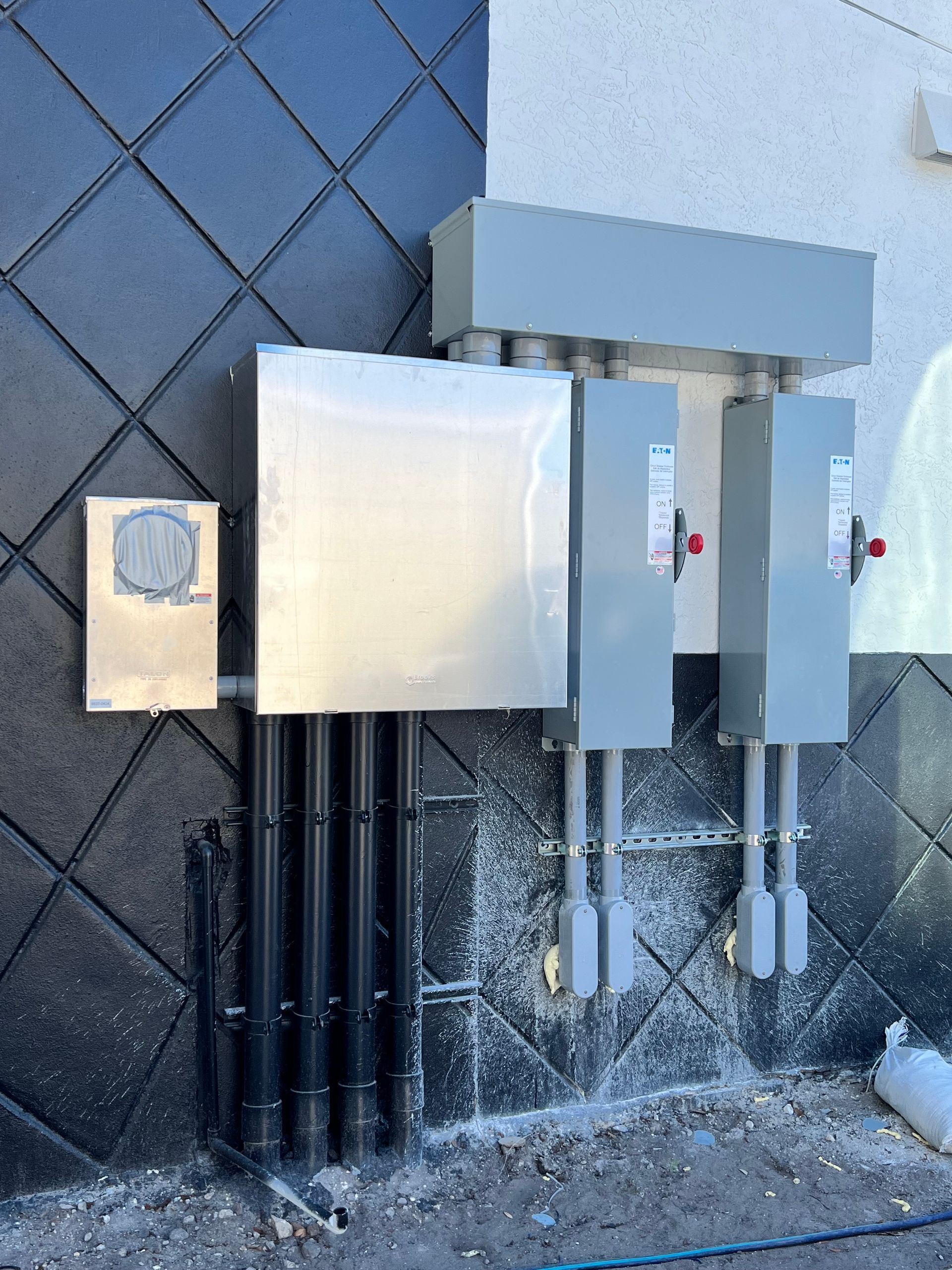 A row of electrical boxes on the side of a building