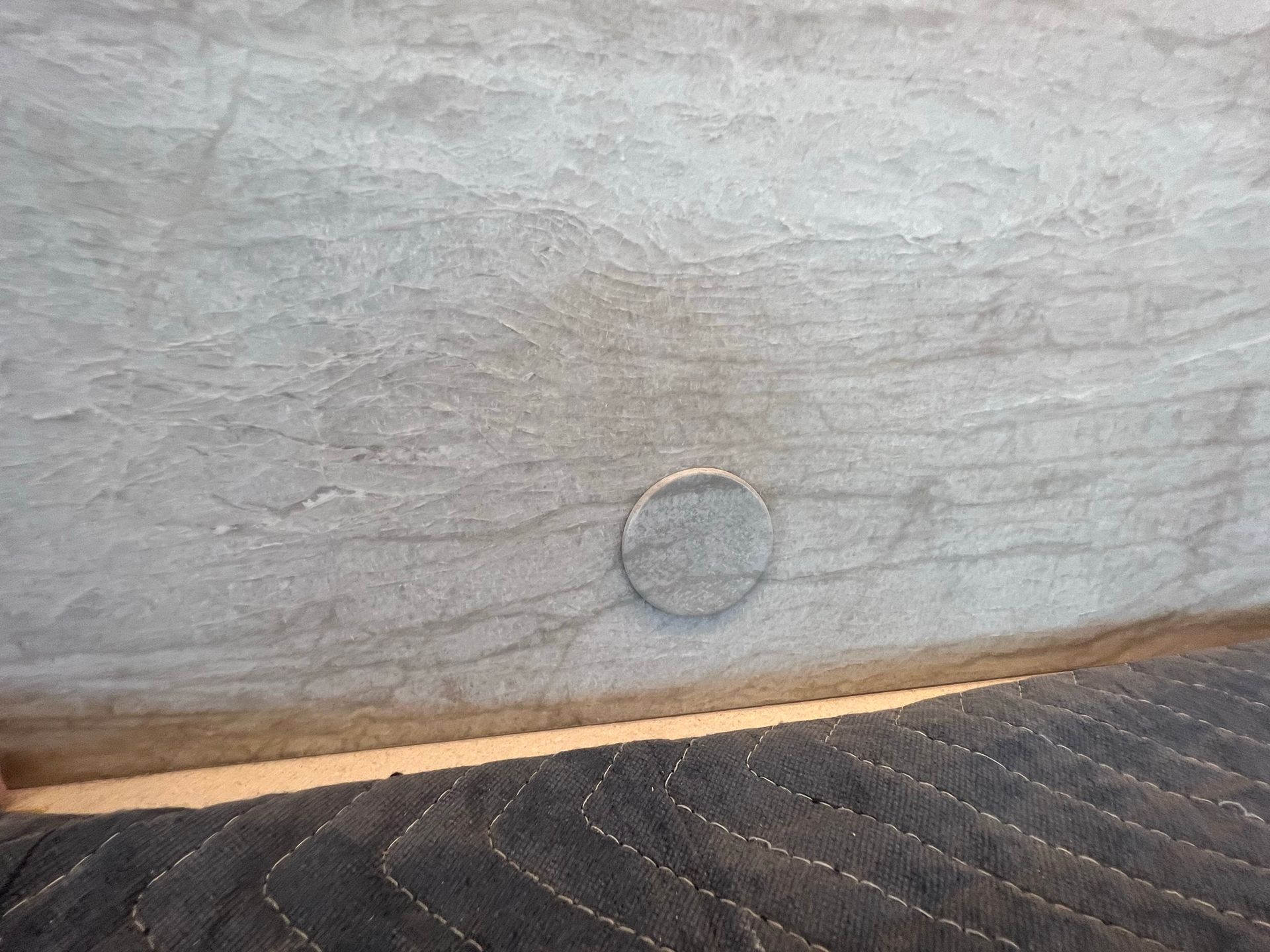 A close up of a piece of wood with a hole in it.