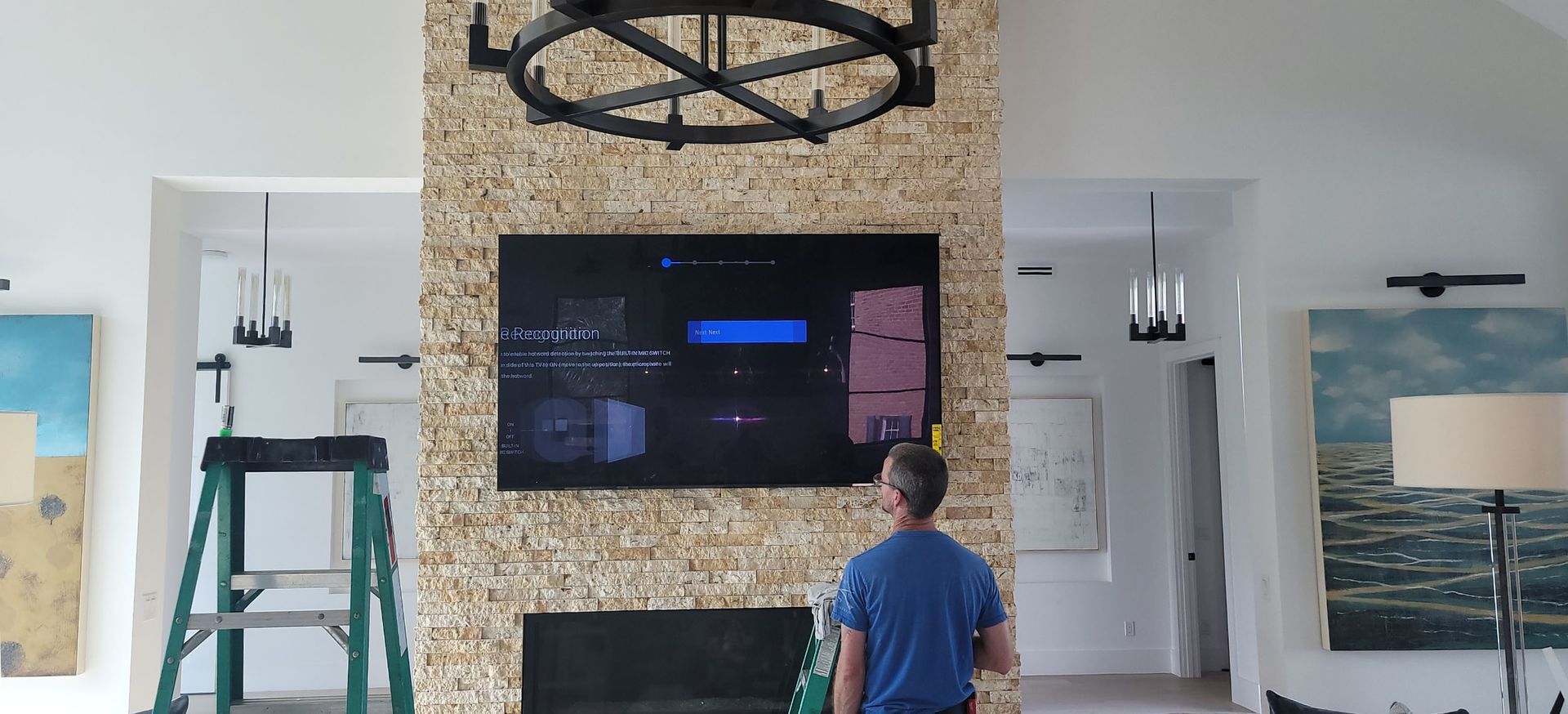 A man is standing in front of a fireplace in a living room.