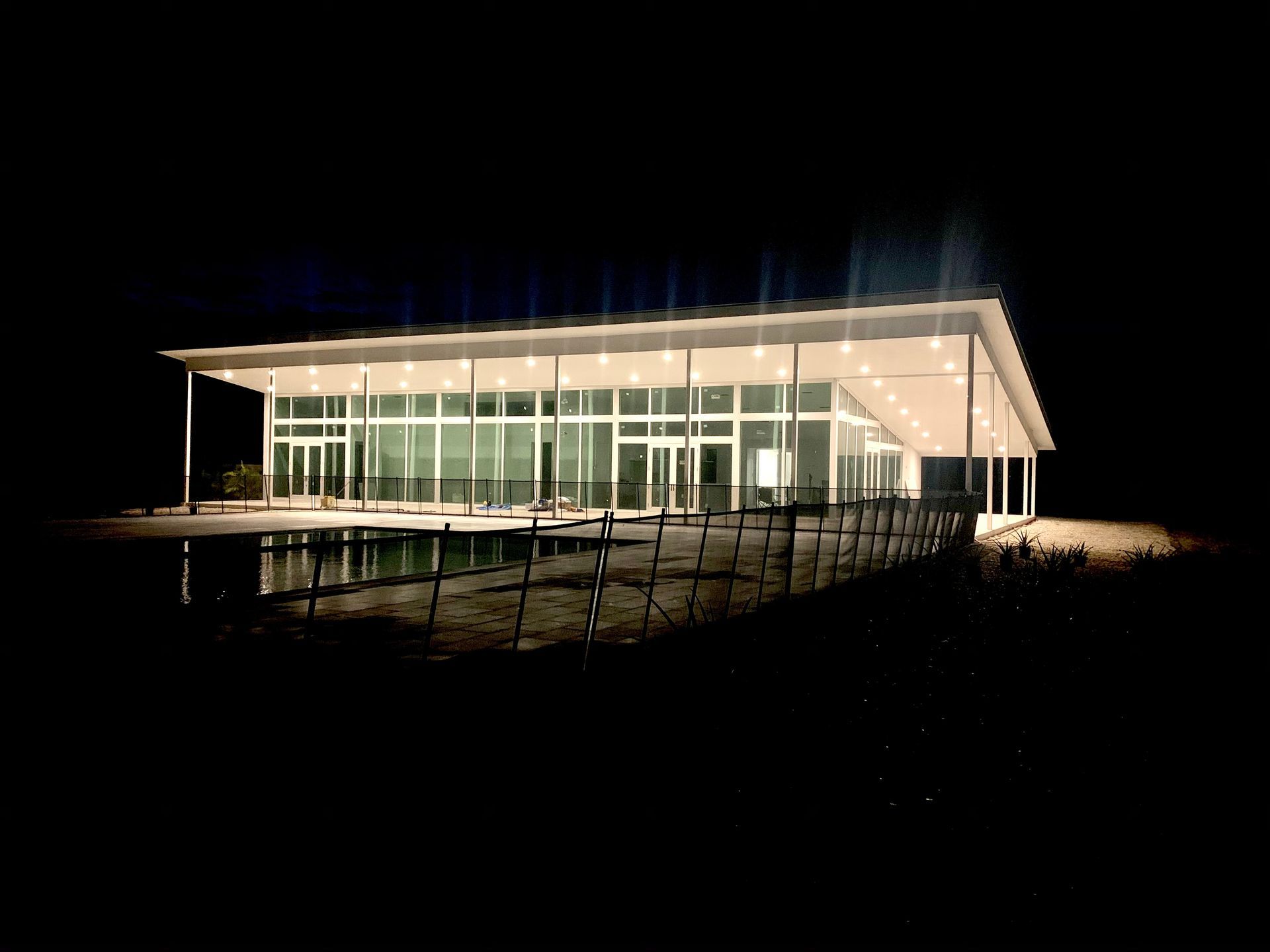 A building with a lot of windows is lit up at night