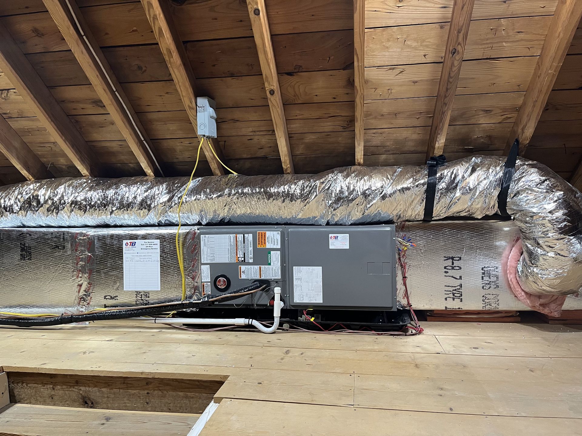 An air conditioner is installed in the attic of a house.