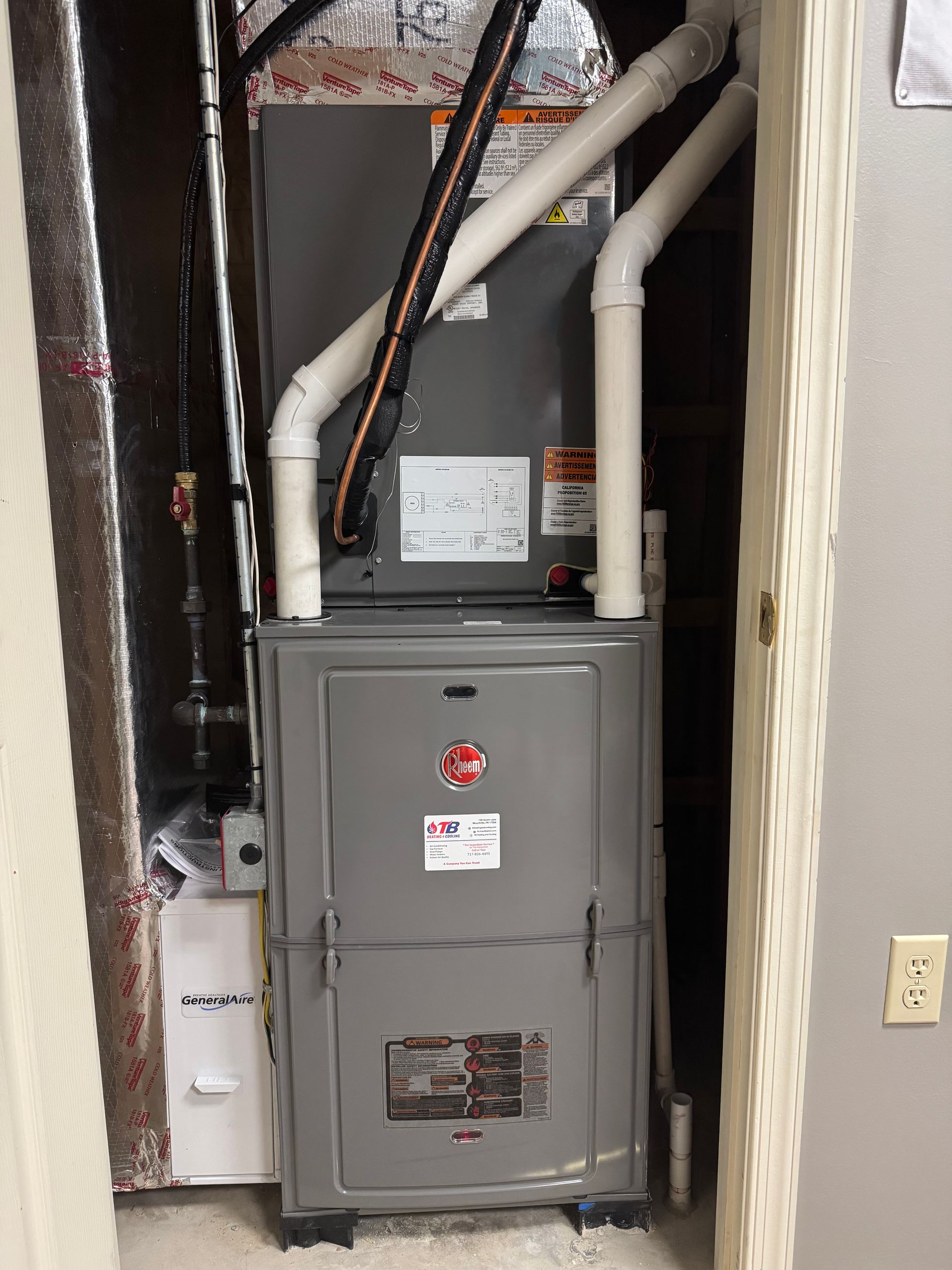 An air conditioner is sitting in a room next to a door.