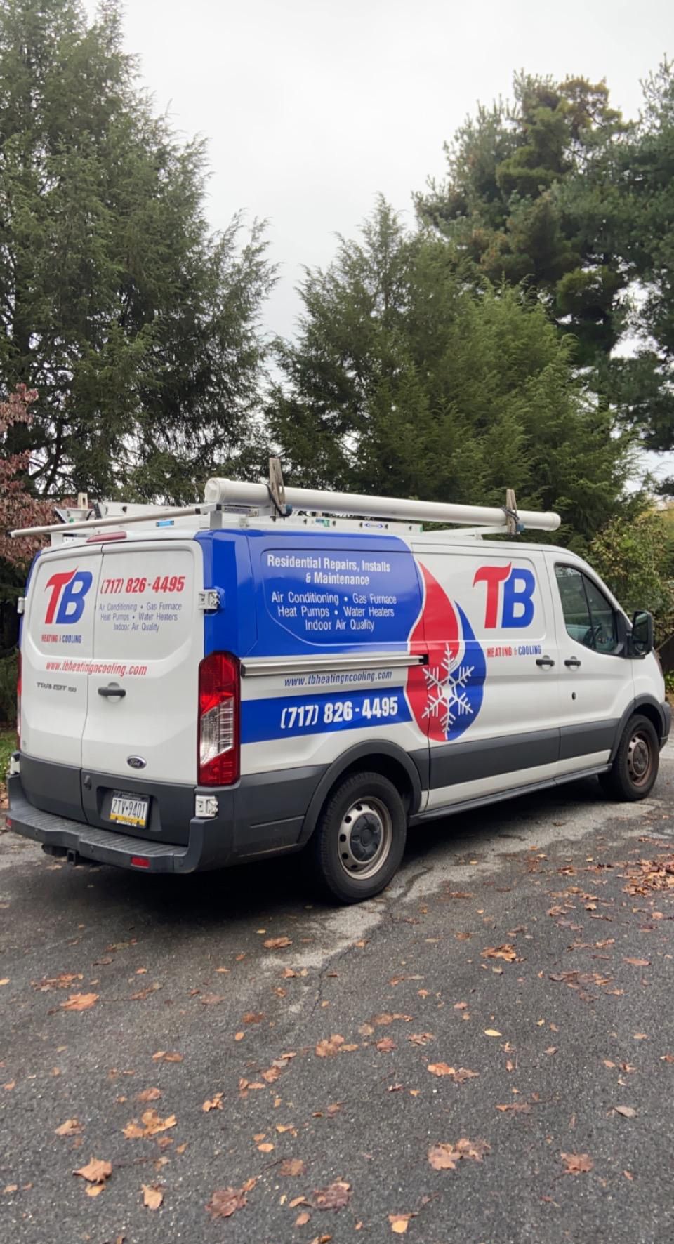 A white van is parked on the side of the road.