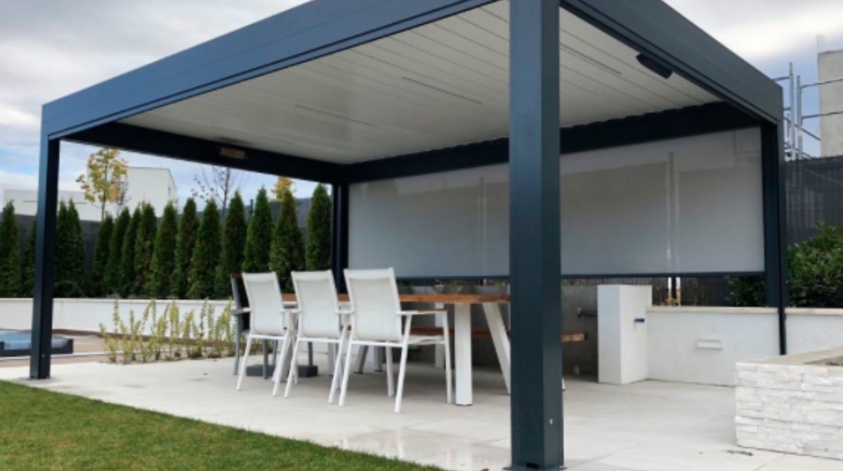 Image of metal pergola with patio furniture under patio cover.