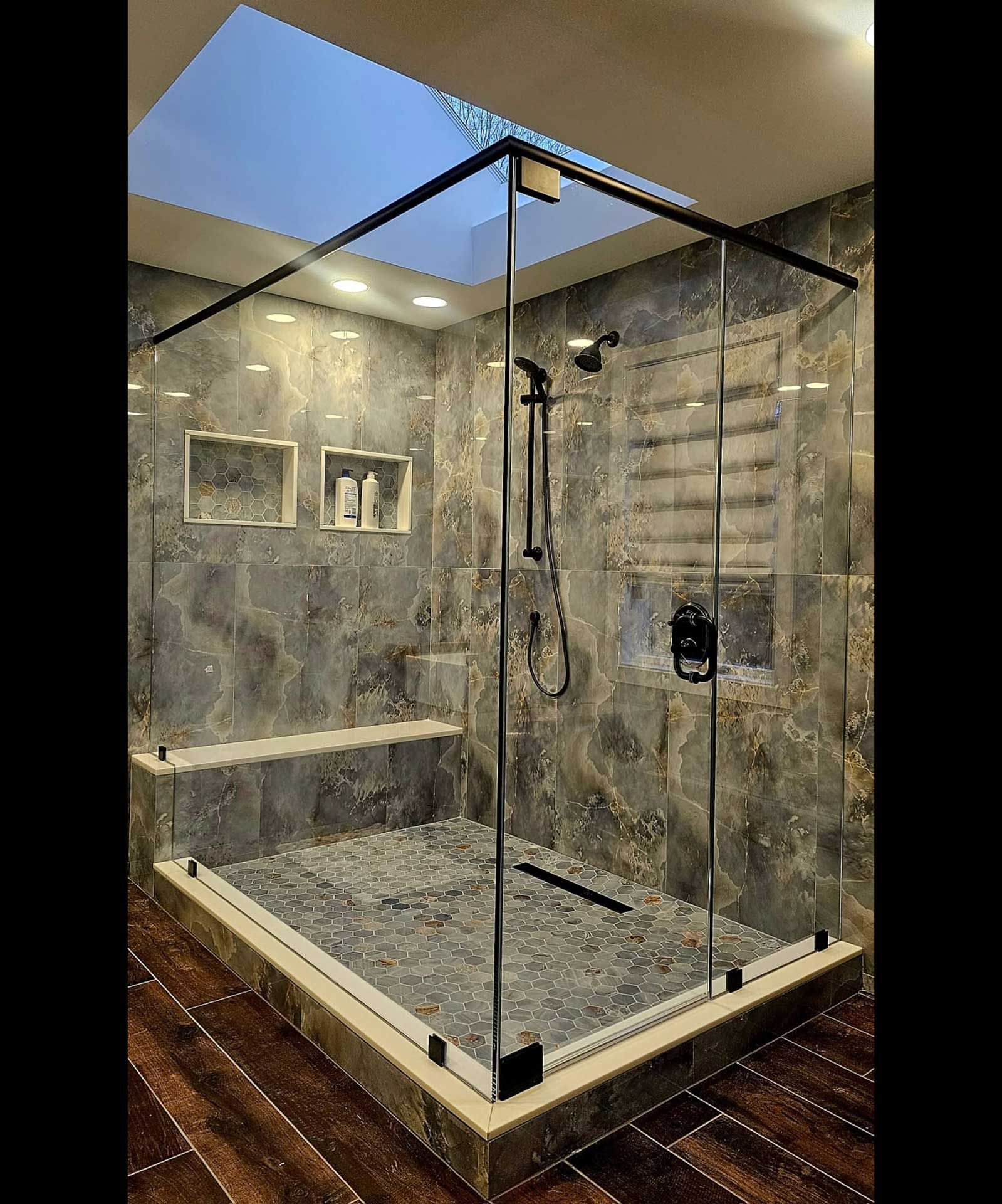 A walk-in shower with a skylight above it