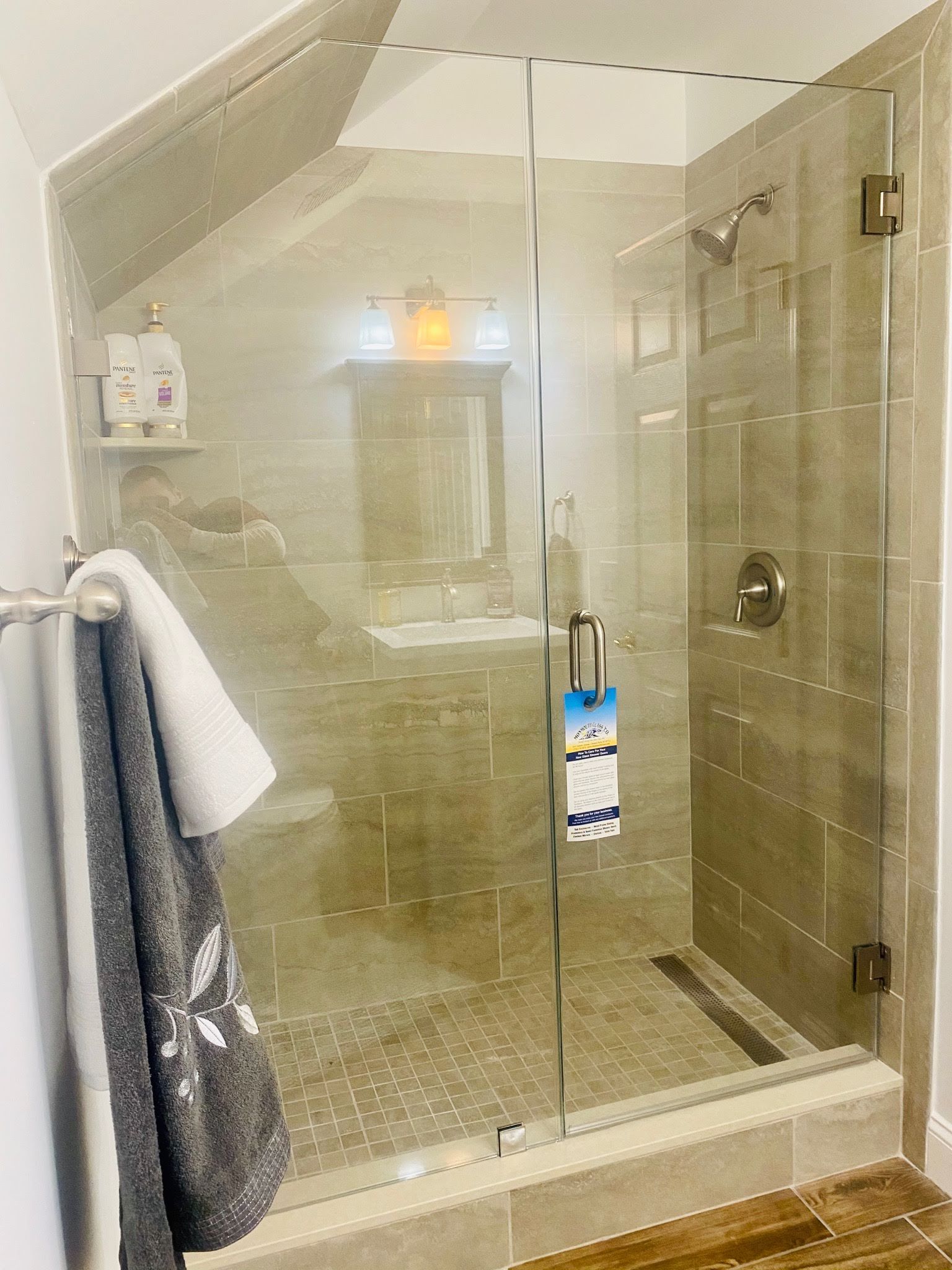 a bathroom with a walk in shower and a sink.