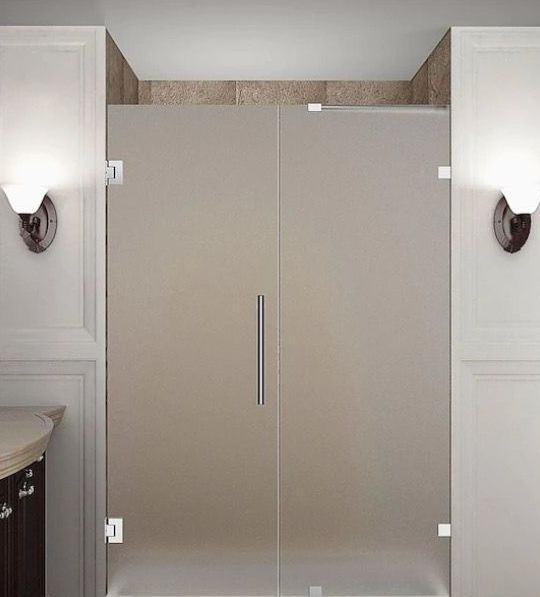 a bathroom with a sliding glass shower door.