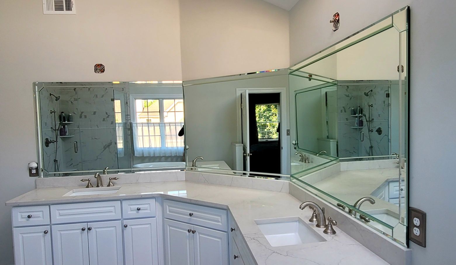a bathroom with two mirrors and a sink.