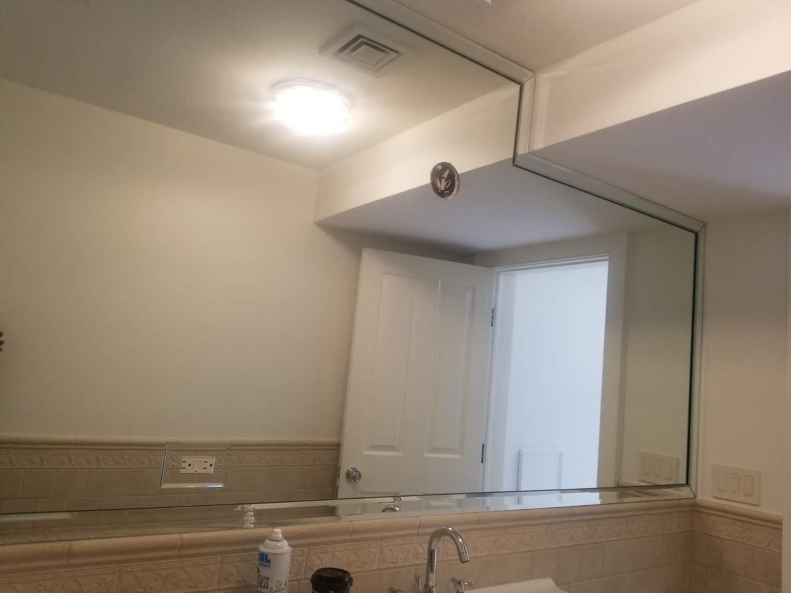 a bathroom with a large mirror and a sink.