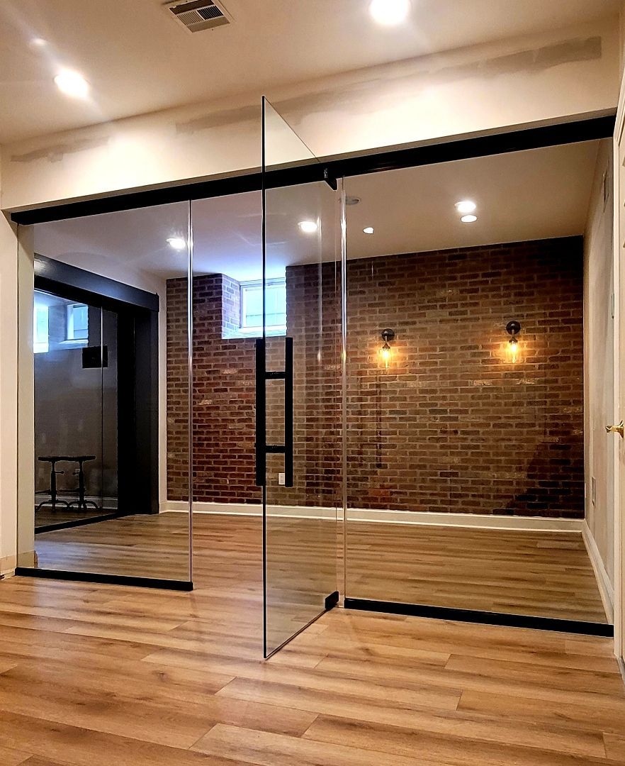 a room with a brick wall and sliding glass doors.