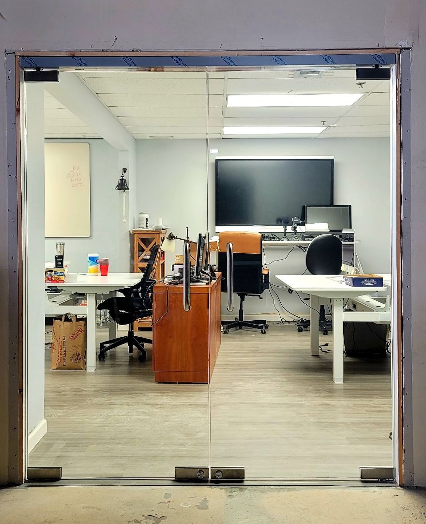 a view of an office through a glass door.