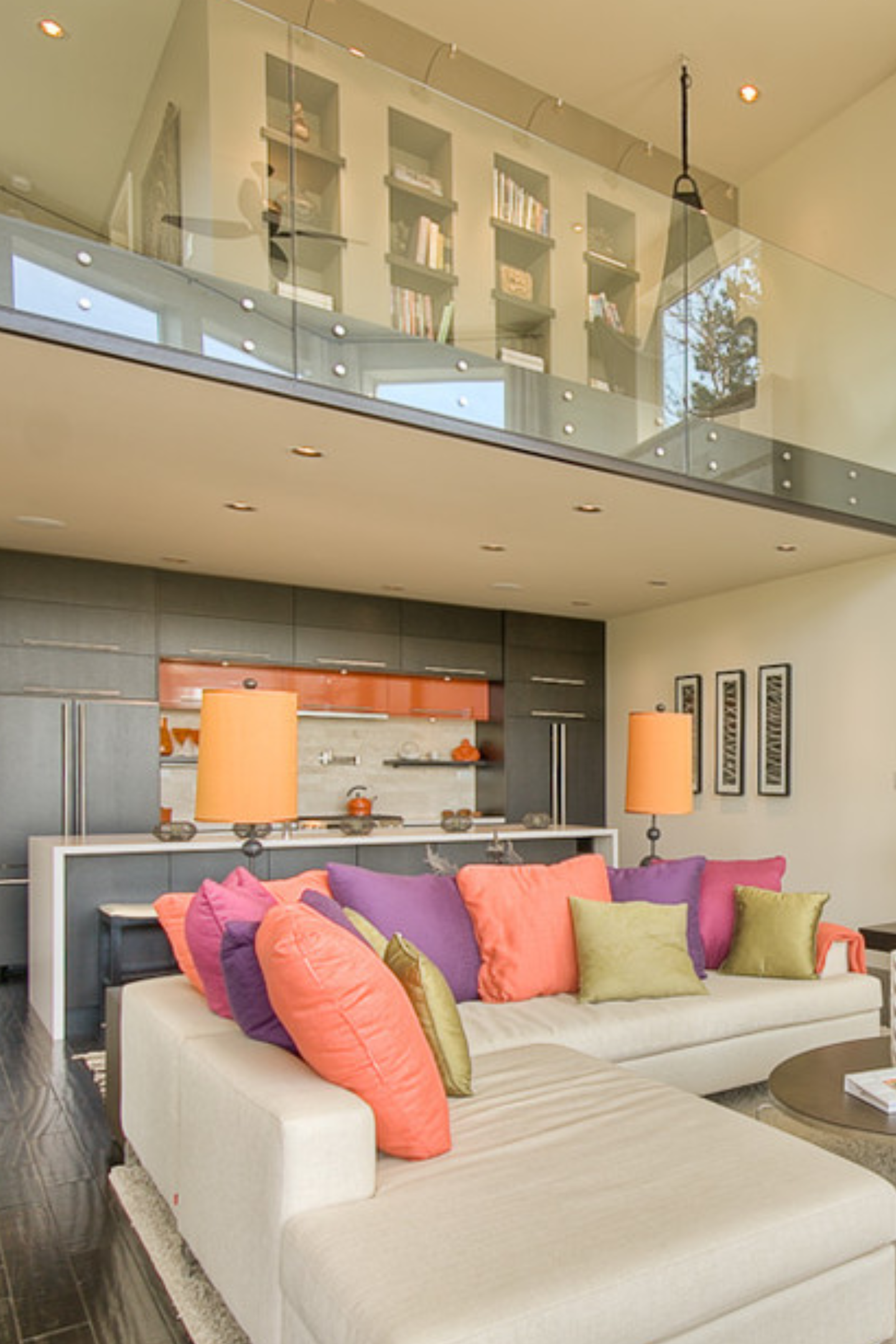 a living room with a white couch and colorful pillows.
