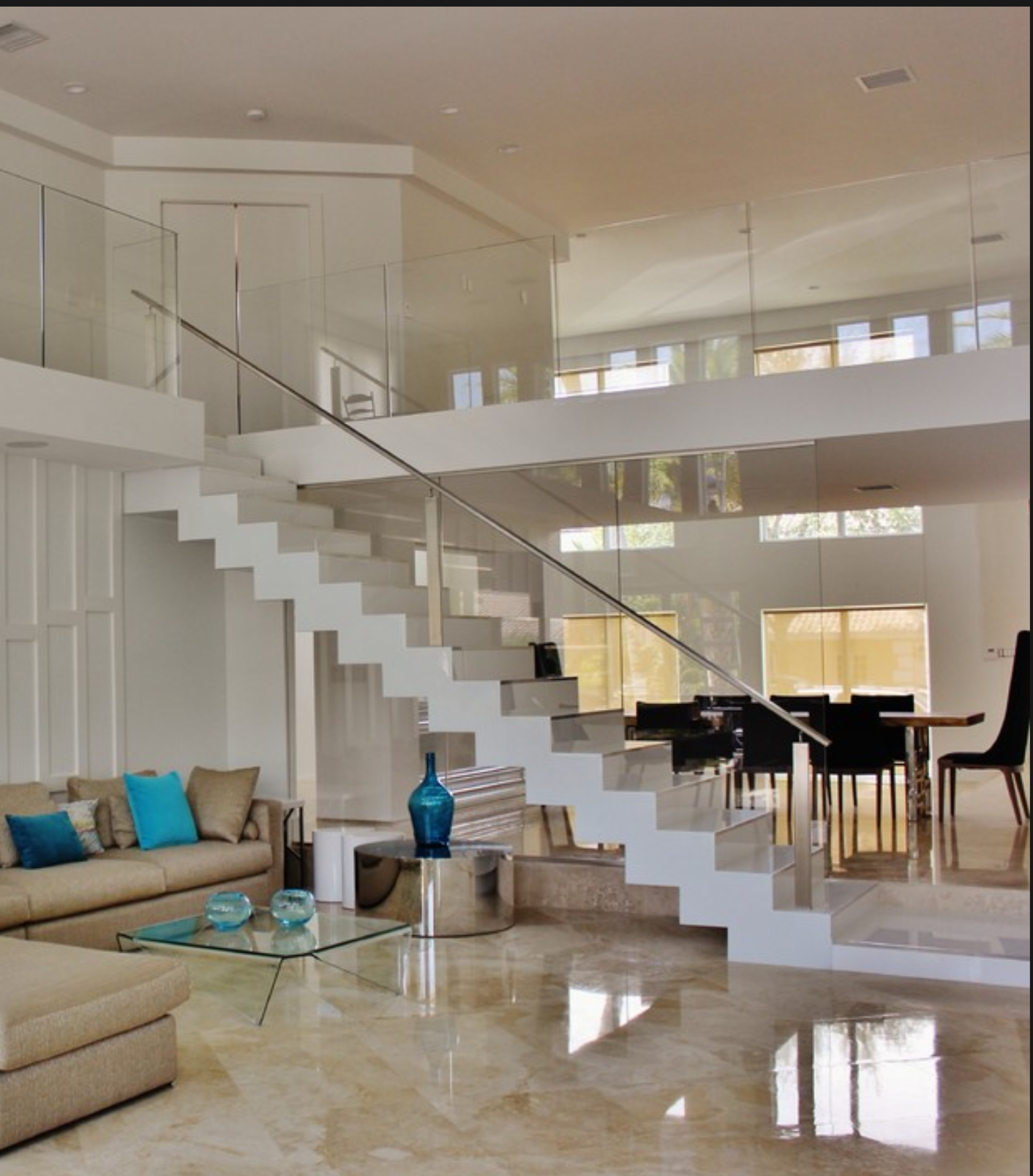 a living room with a staircase leading up to the second floor.