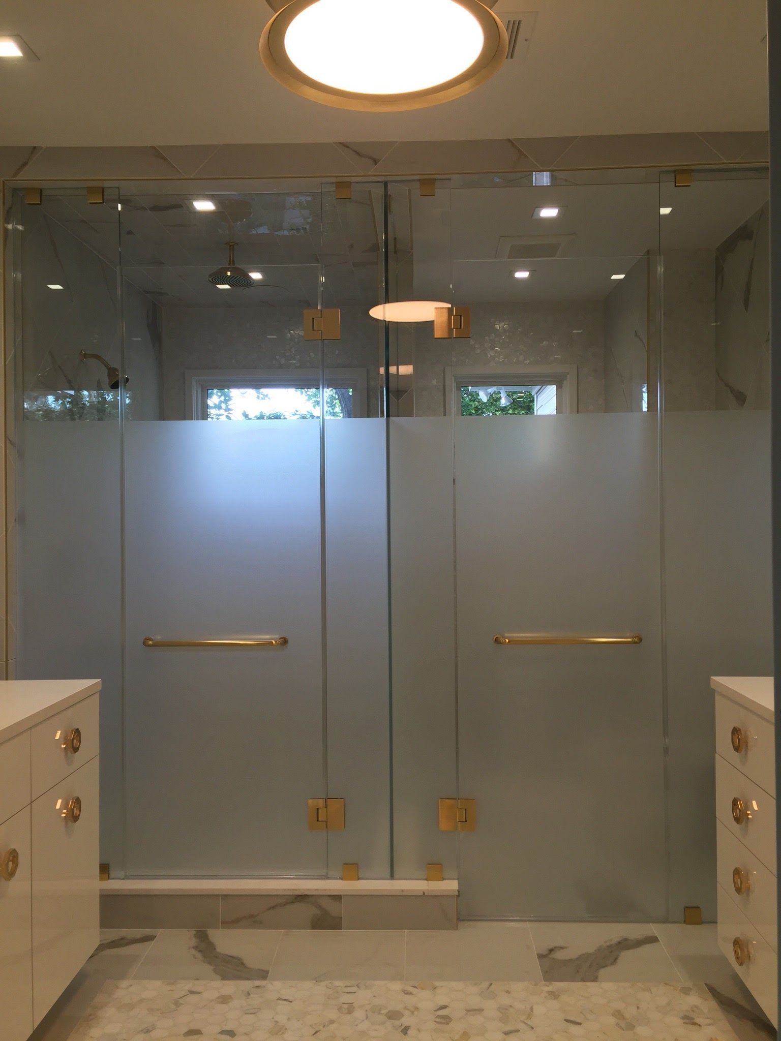 a bathroom with a sliding glass shower door.