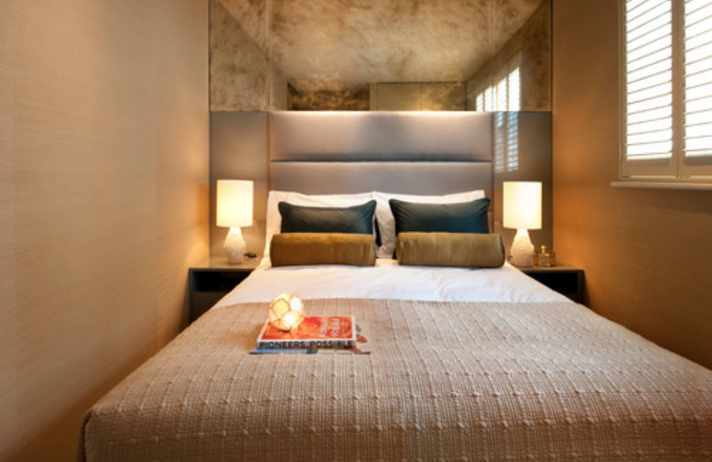 a bedroom with a bed and a magazine on the bed.