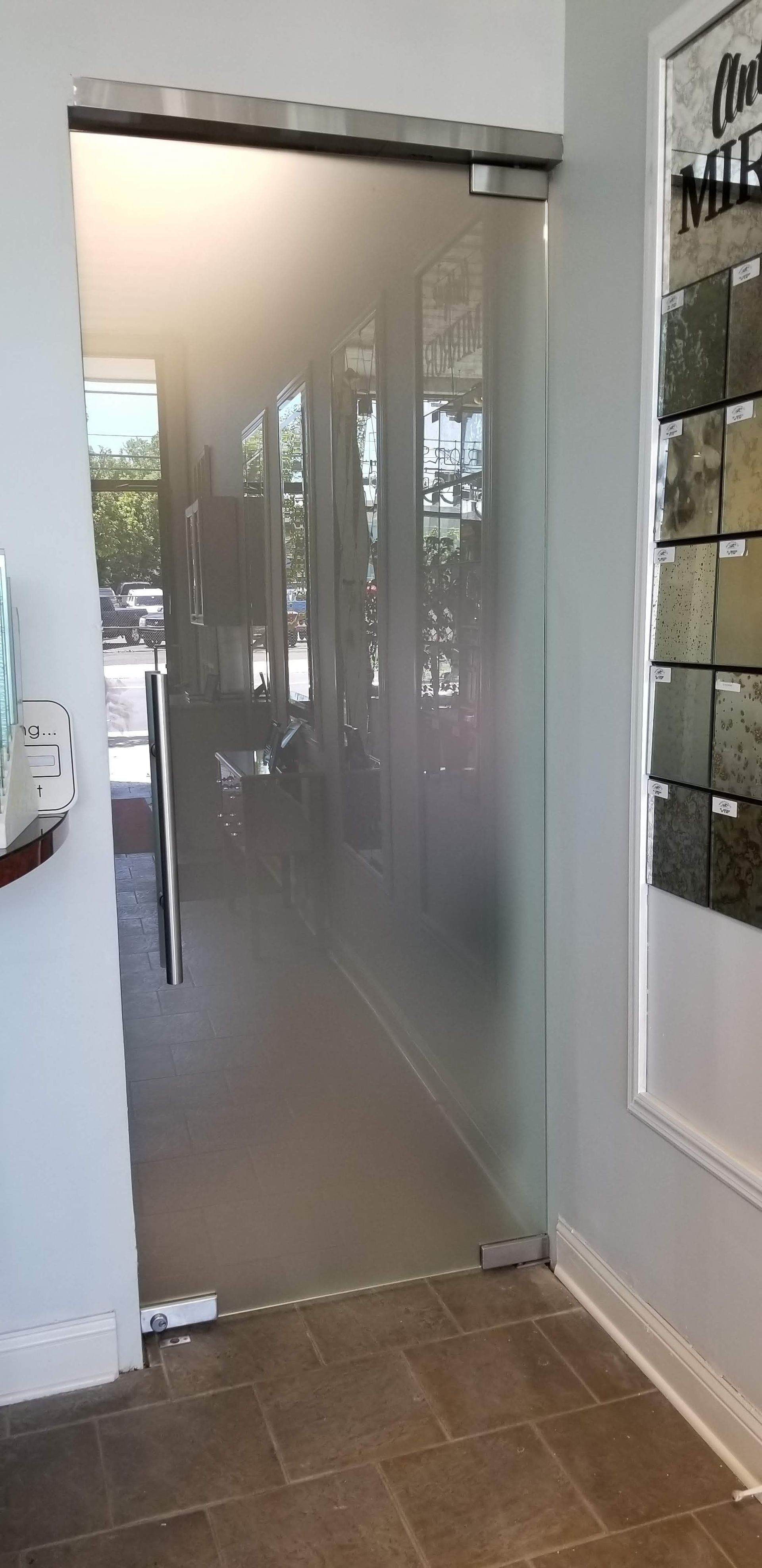 a glass door with a sliding glass door in a room.