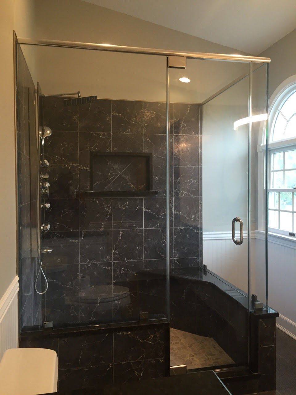 a bathroom with a sliding glass shower door.