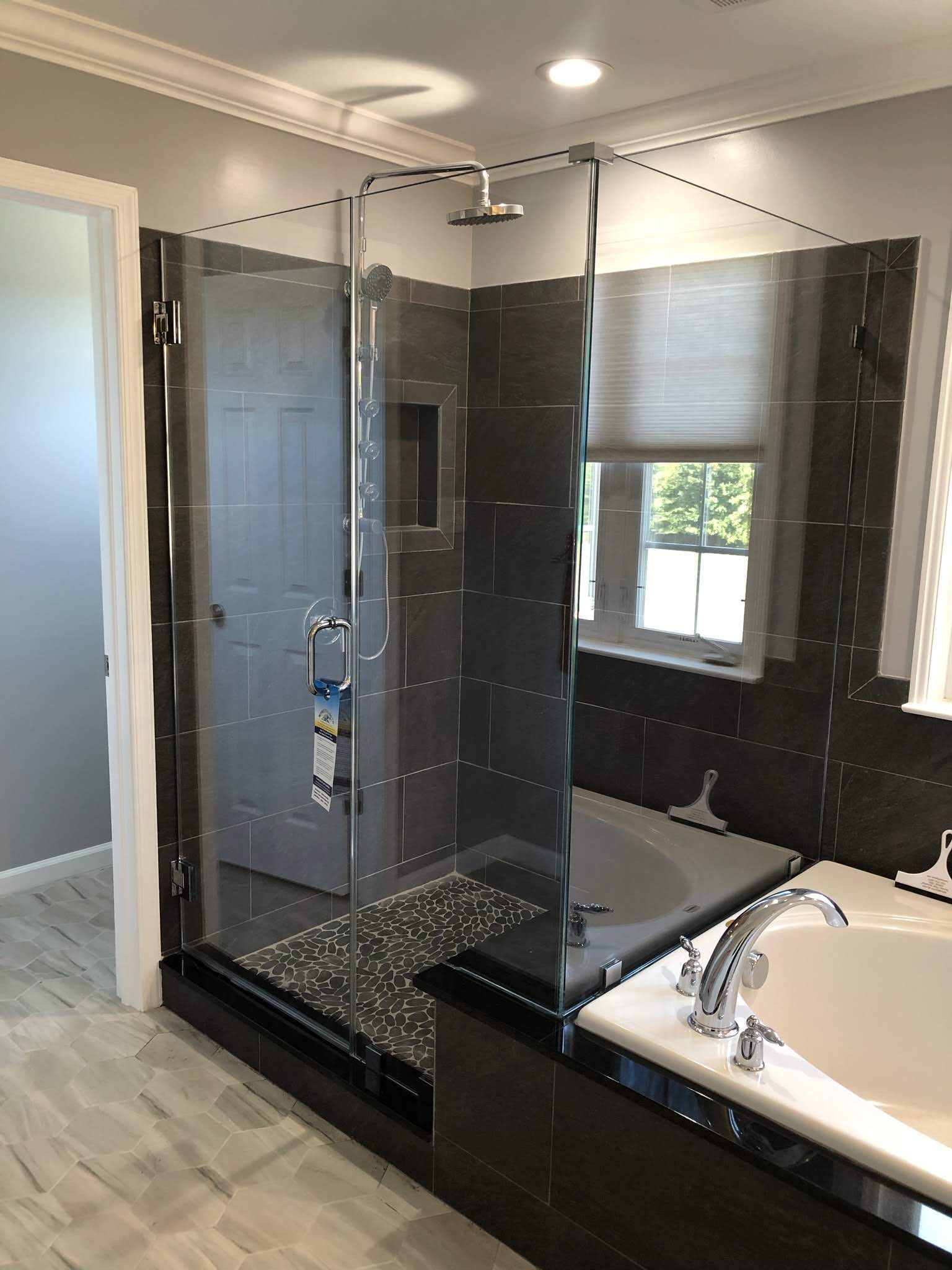 a bathroom with a walk in shower and a bathtub.