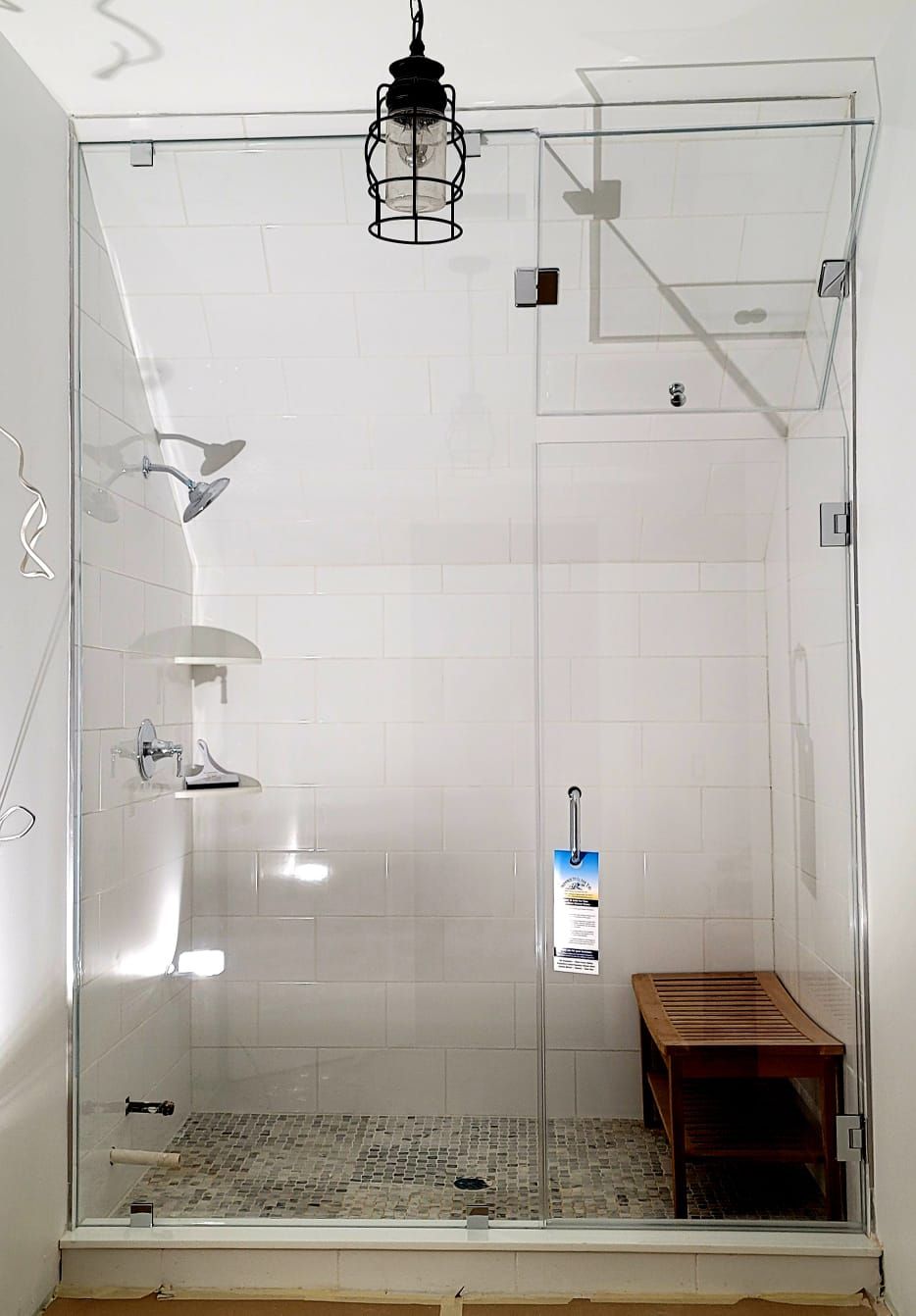 a bathroom with a walk in shower with a glass door.