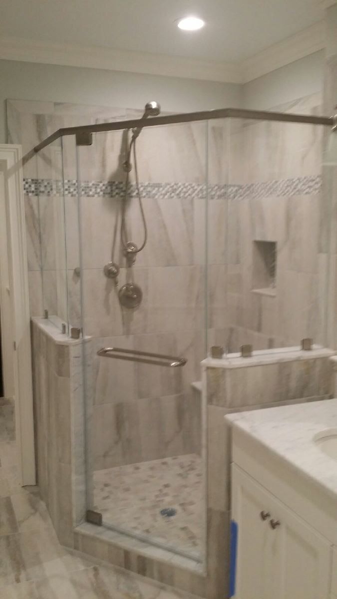 a bathroom with a walk in shower and a sink.