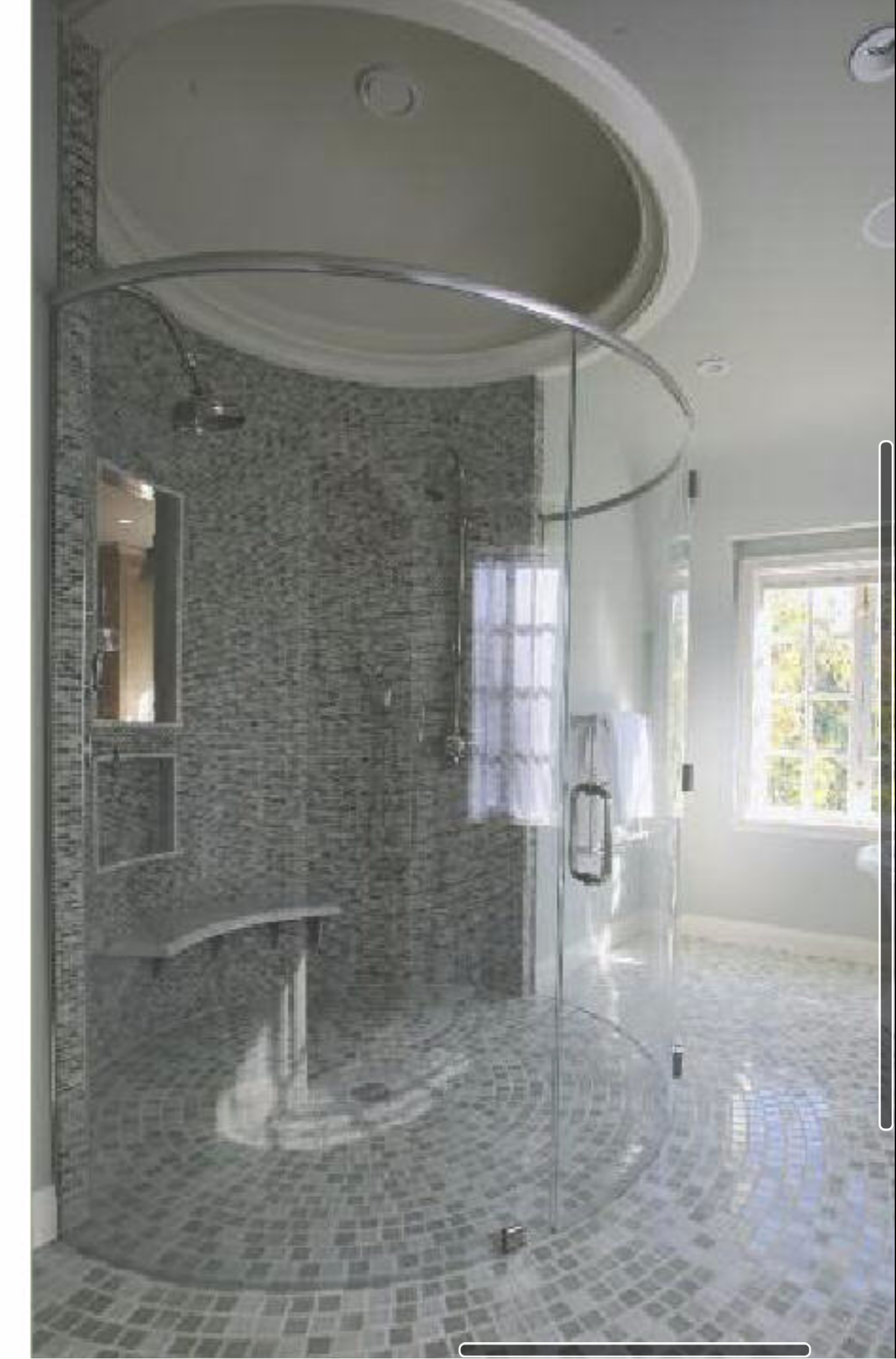 a bathroom with a walk in shower and a window.