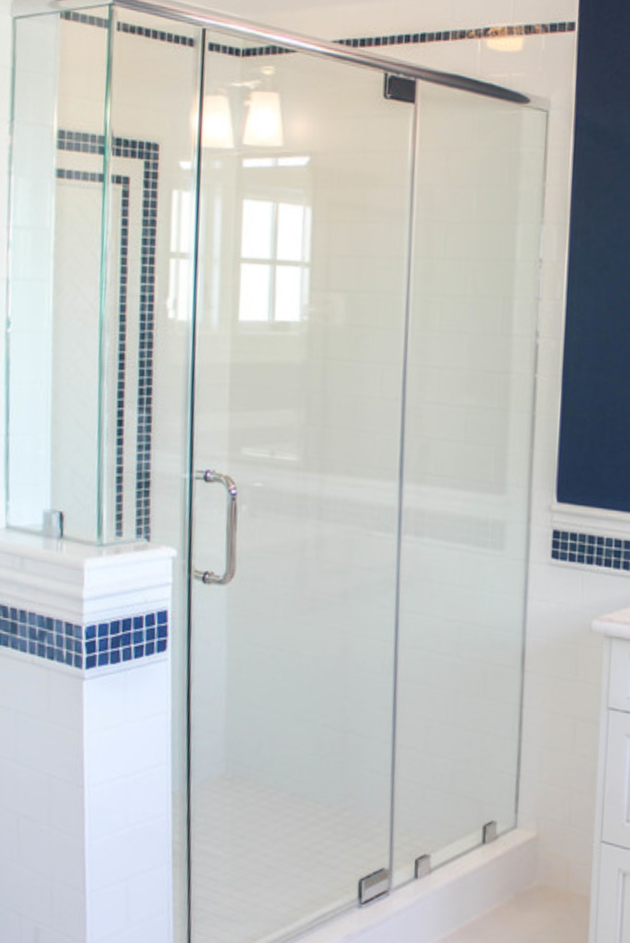 a bathroom with a sliding glass shower door.