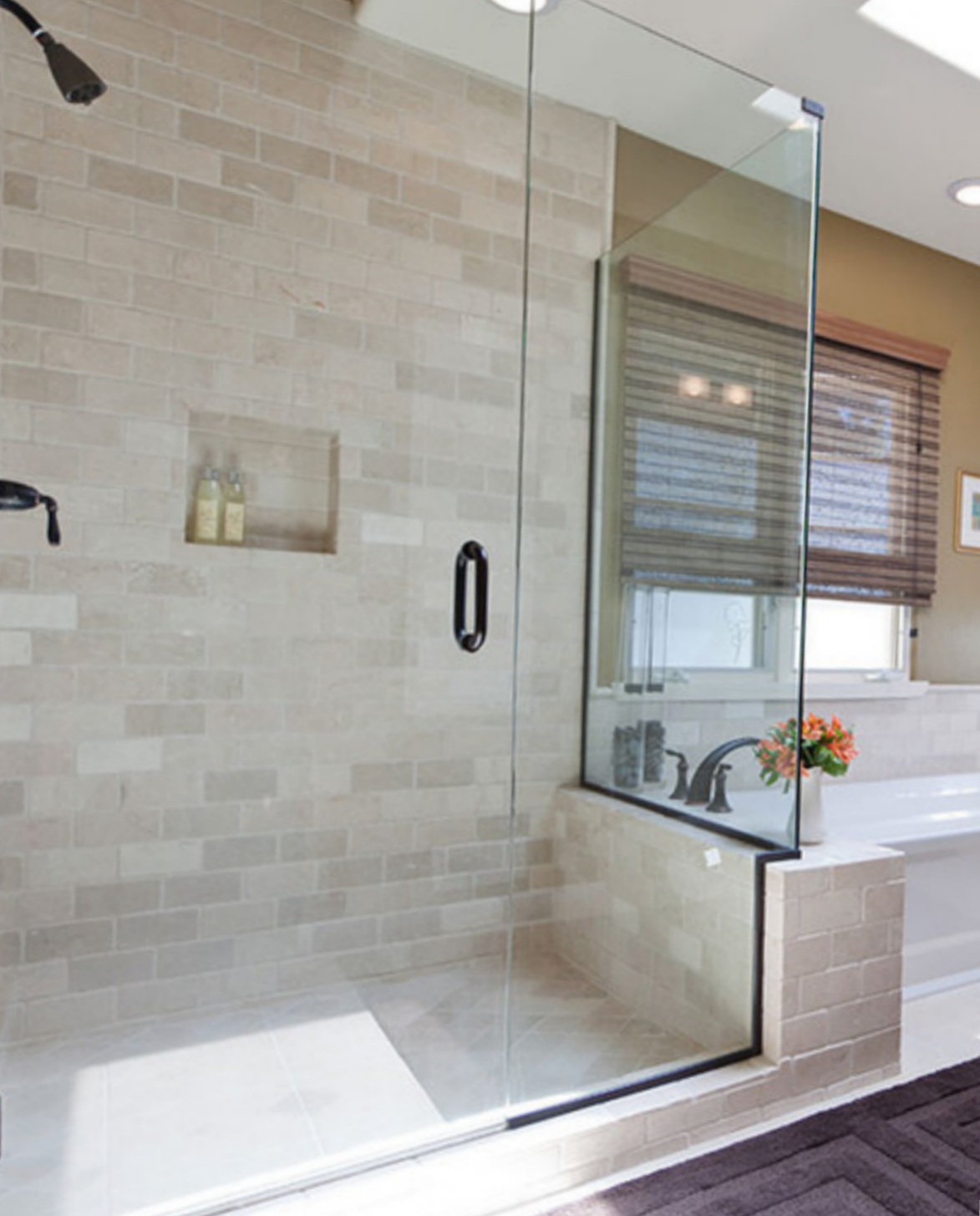 a bathroom with a walk in shower and a bathtub.